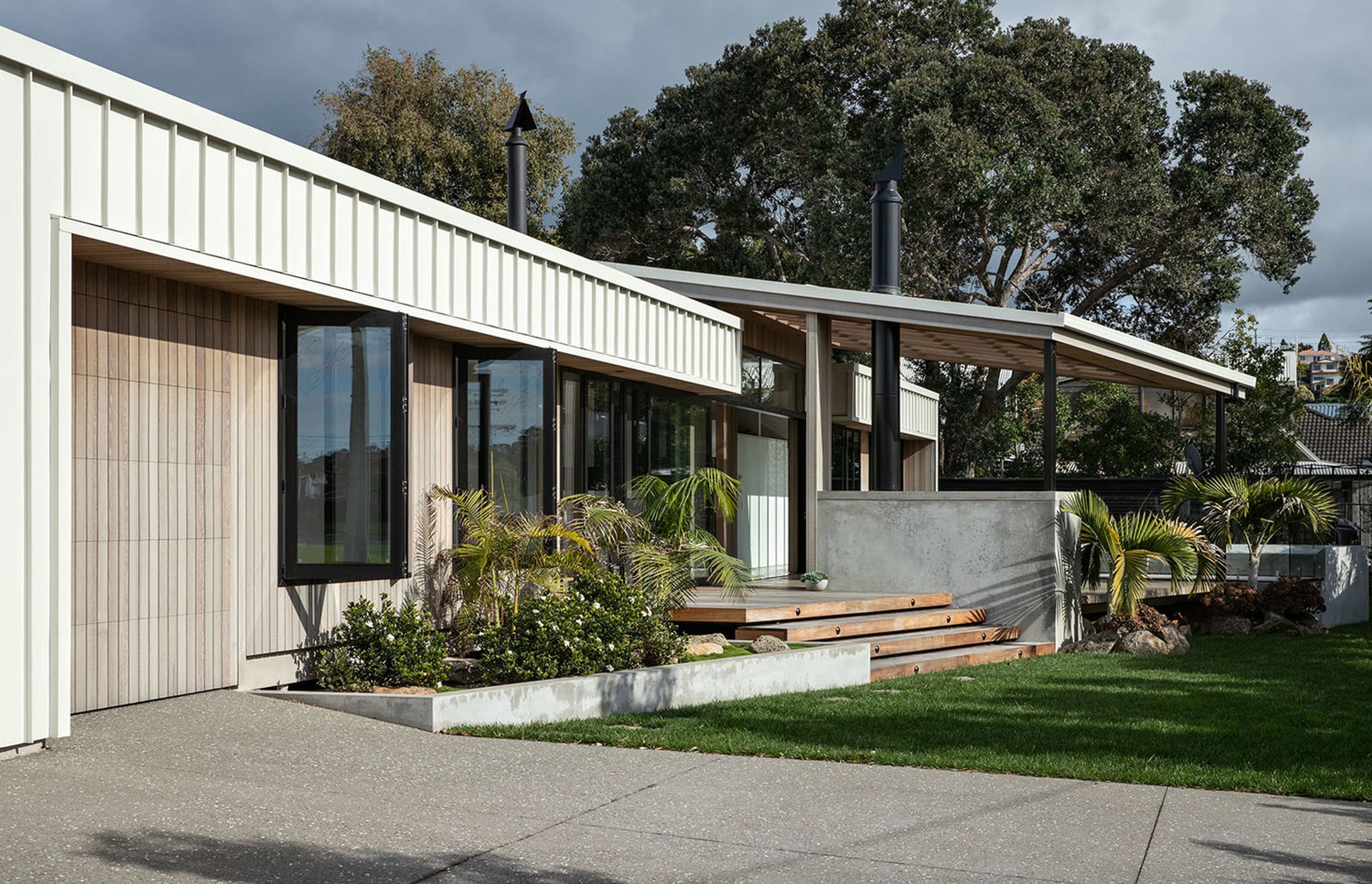 The large garage has been made discreet with vertical cedar panelling on the walls and doors.