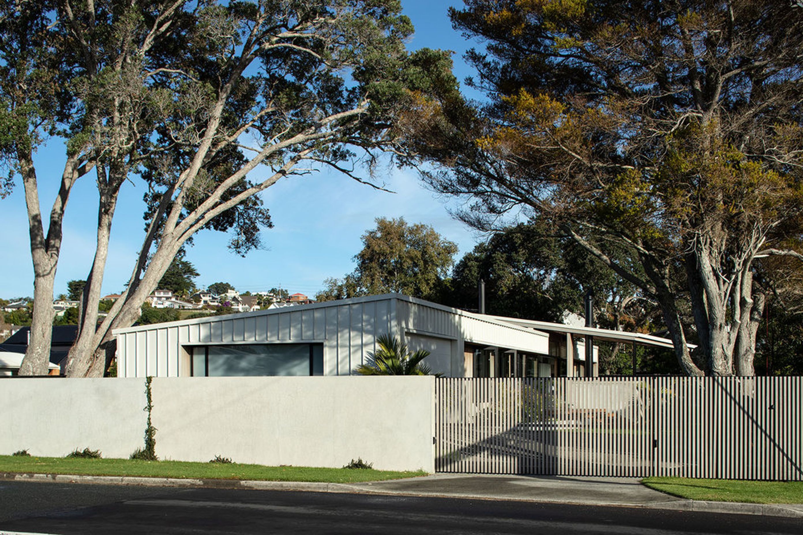 Flying Cloud from the street view with the discreet garaging seen on the left and the sliding entrance door into the driveway on the right.