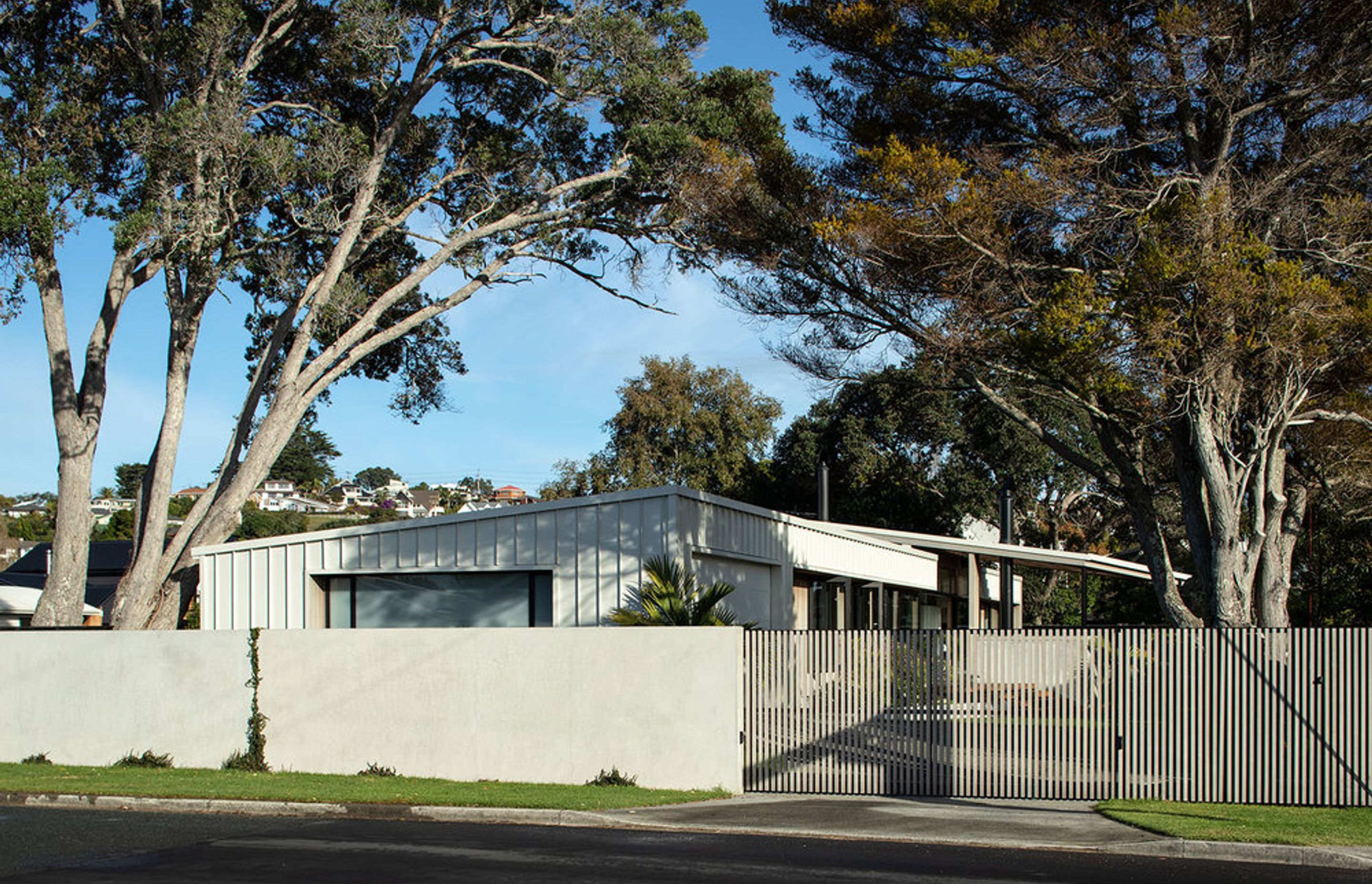 Flying Cloud from the street view with the discreet garaging seen on the left and the sliding entrance door into the driveway on the right.