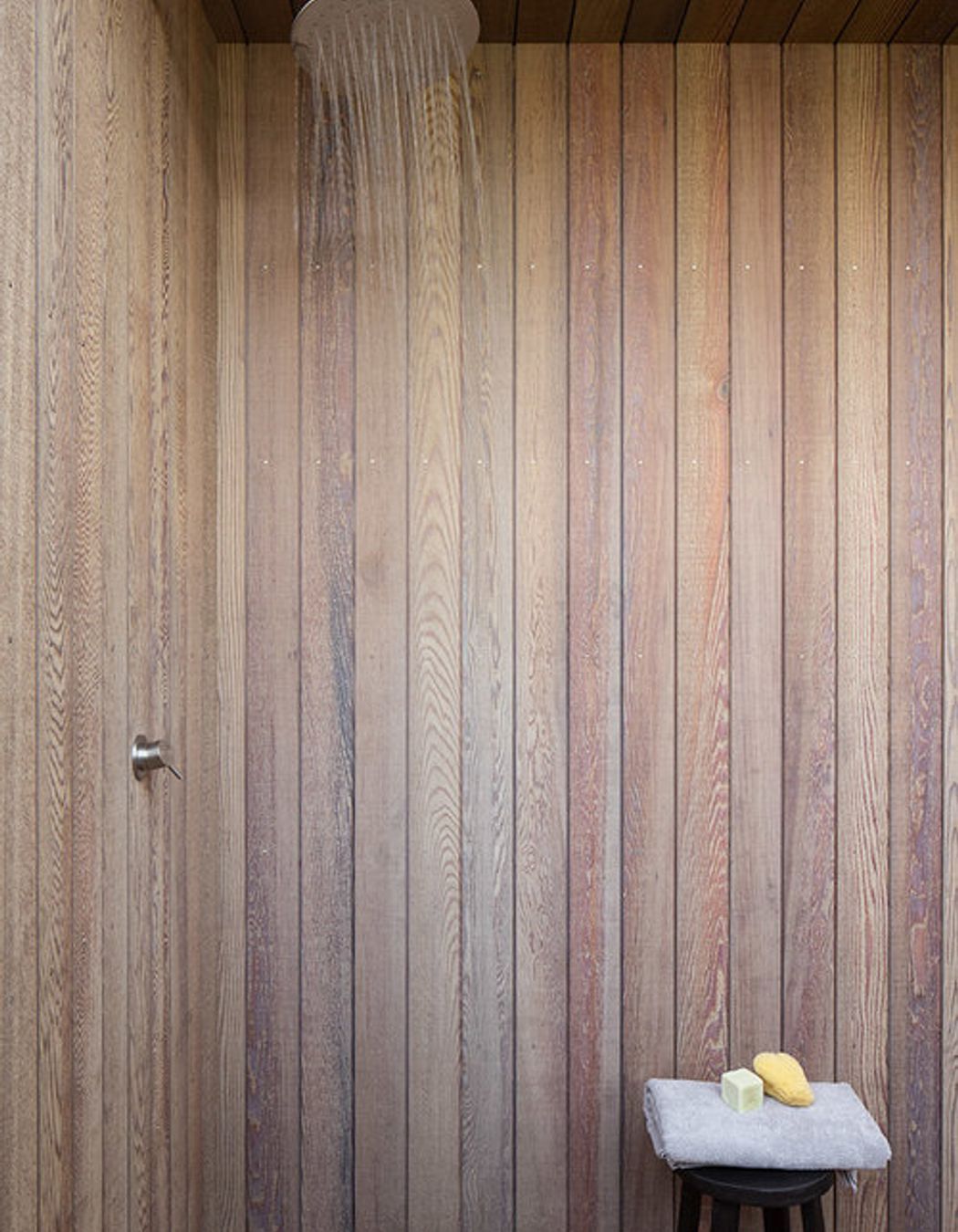 The timber-lined outdoor shower is perfect for washing sand off visits to the beach.