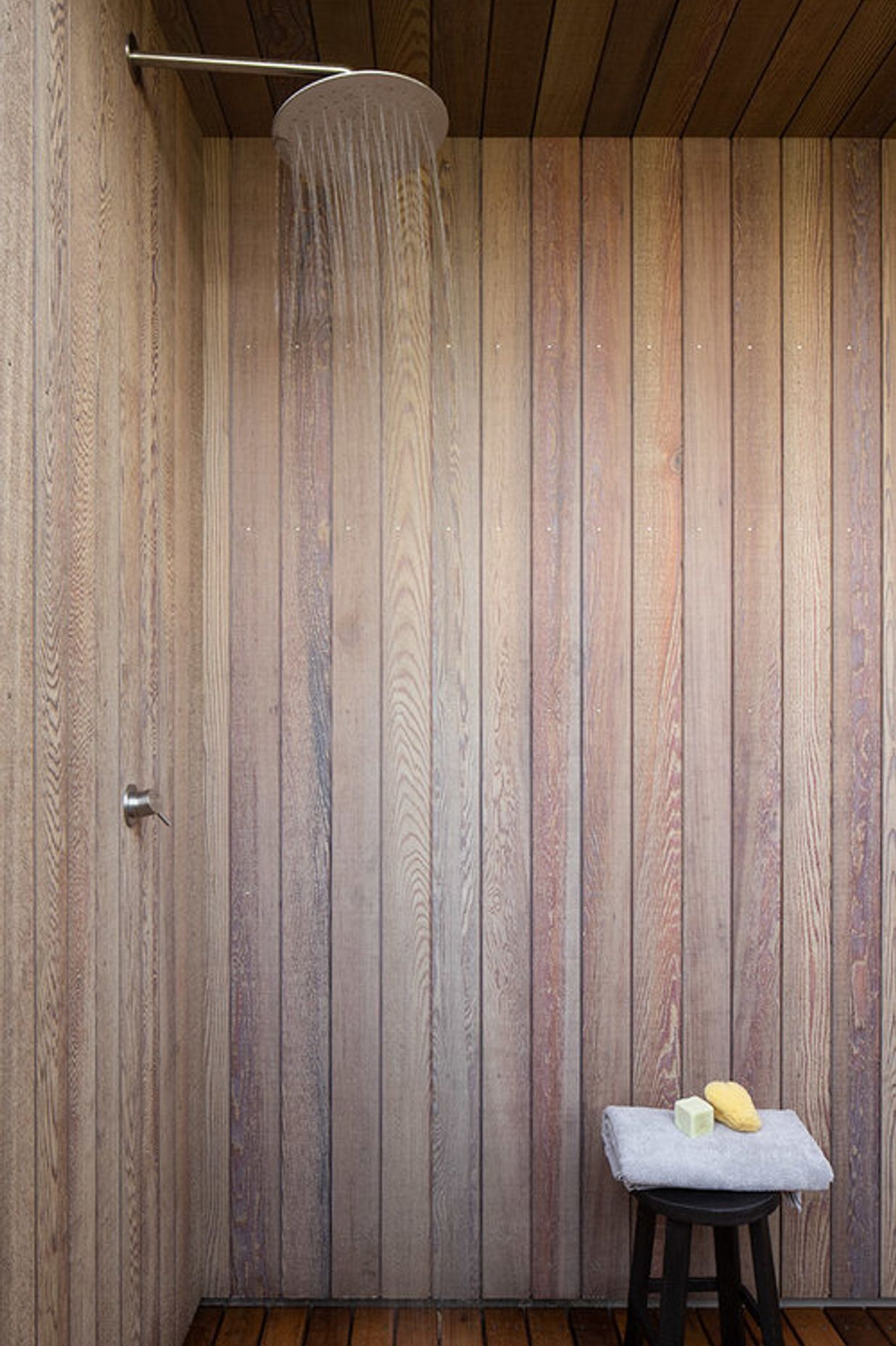 The timber-lined outdoor shower is perfect for washing sand off visits to the beach.