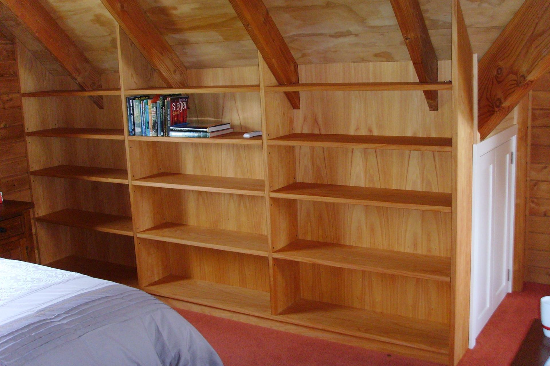 Built-in book shelves under roof eaves