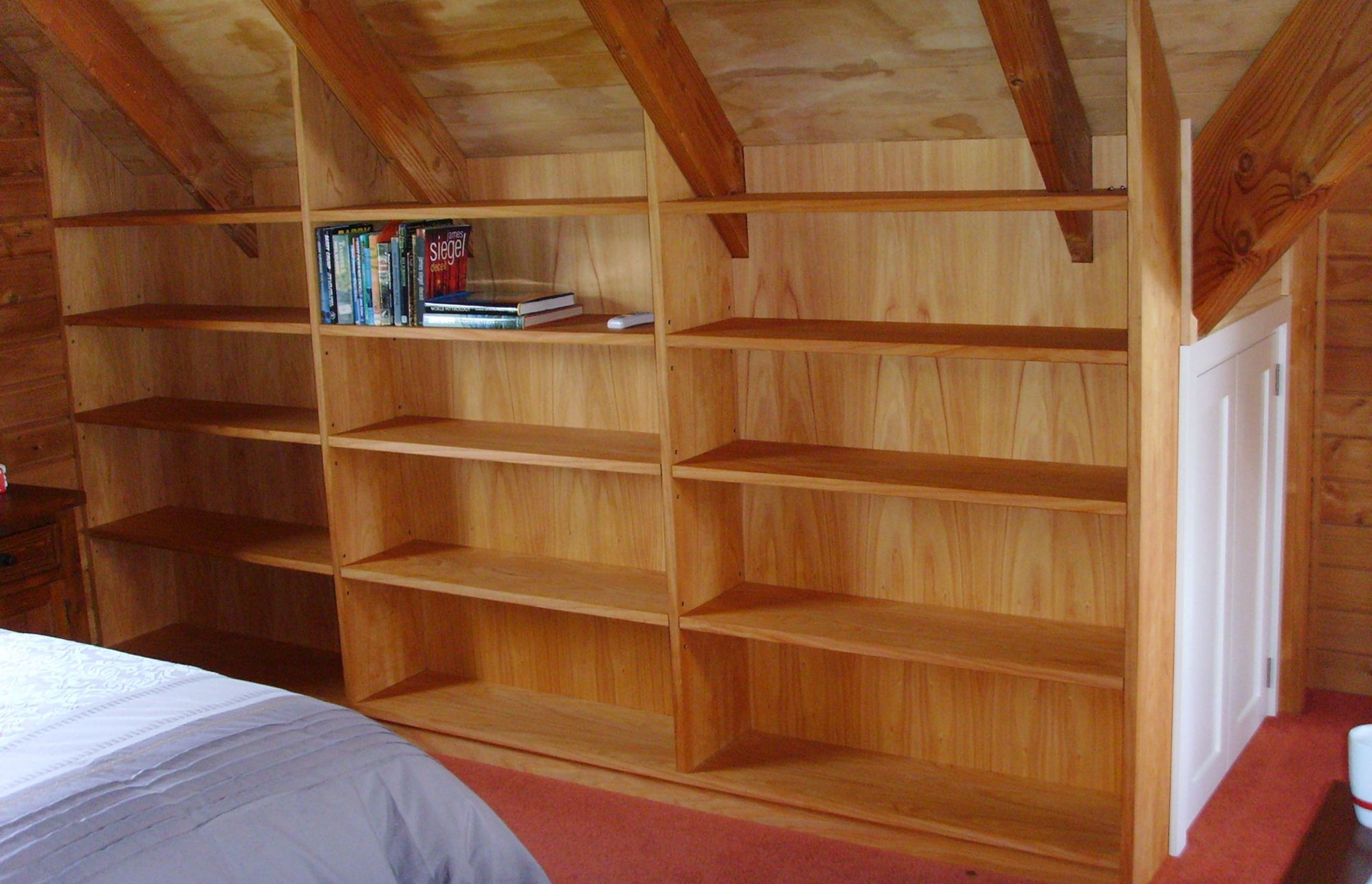 Built-in book shelves under roof eaves