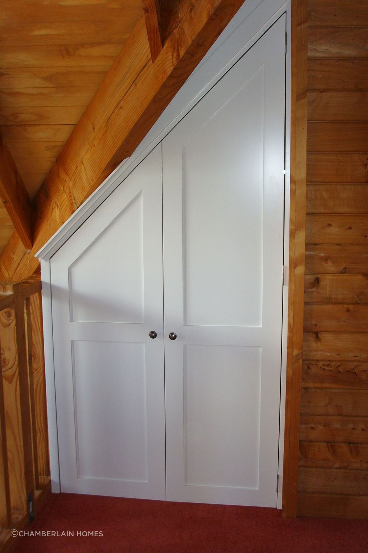 Storage cupboard in-built under roof eaves.