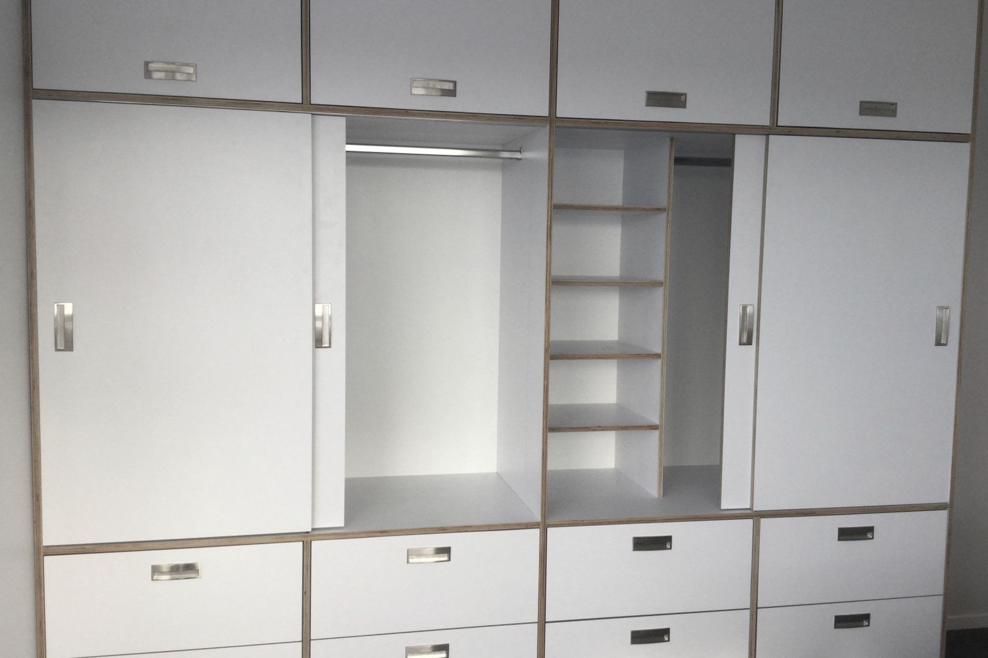 Custom-built wardrobe amd drawers made from HPL italia on Birch ply from Plymasters. Recessed Brushed Nickel Arezzo Handles by Archant. Other door hardware by Hafele.