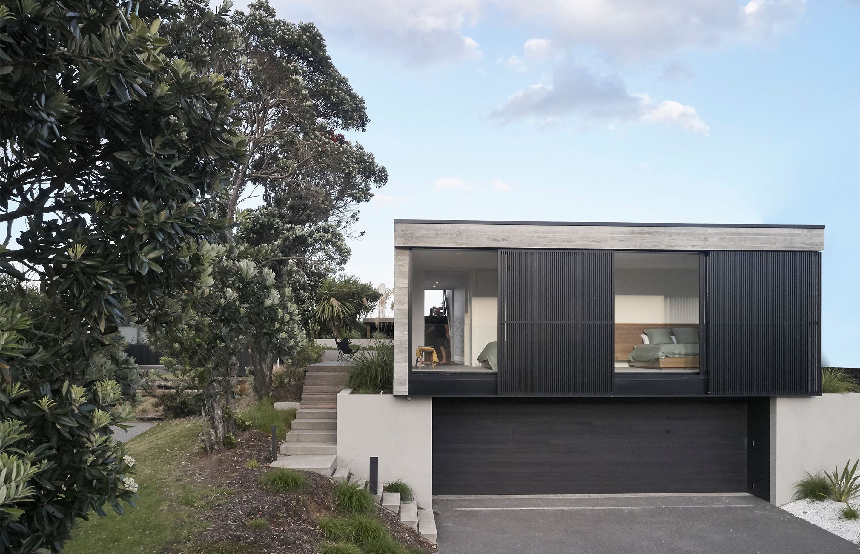 Approaching the garaging from the street, there is a sense that this level was built into the sloping slight rather than dominating it.