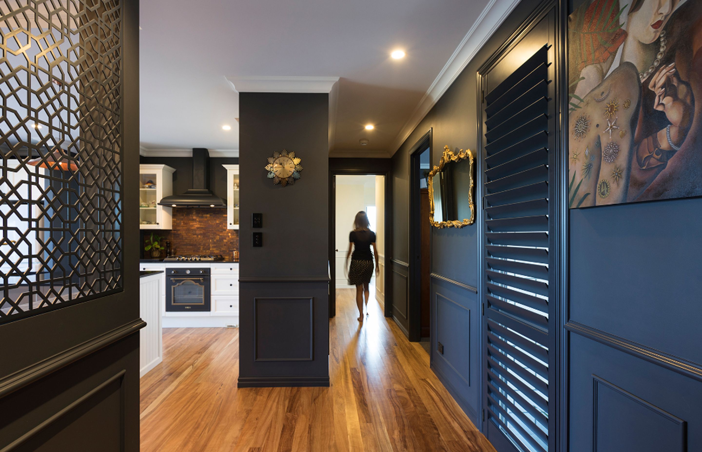 Custom coloured shutters and metal screens provide privacy in the entrance