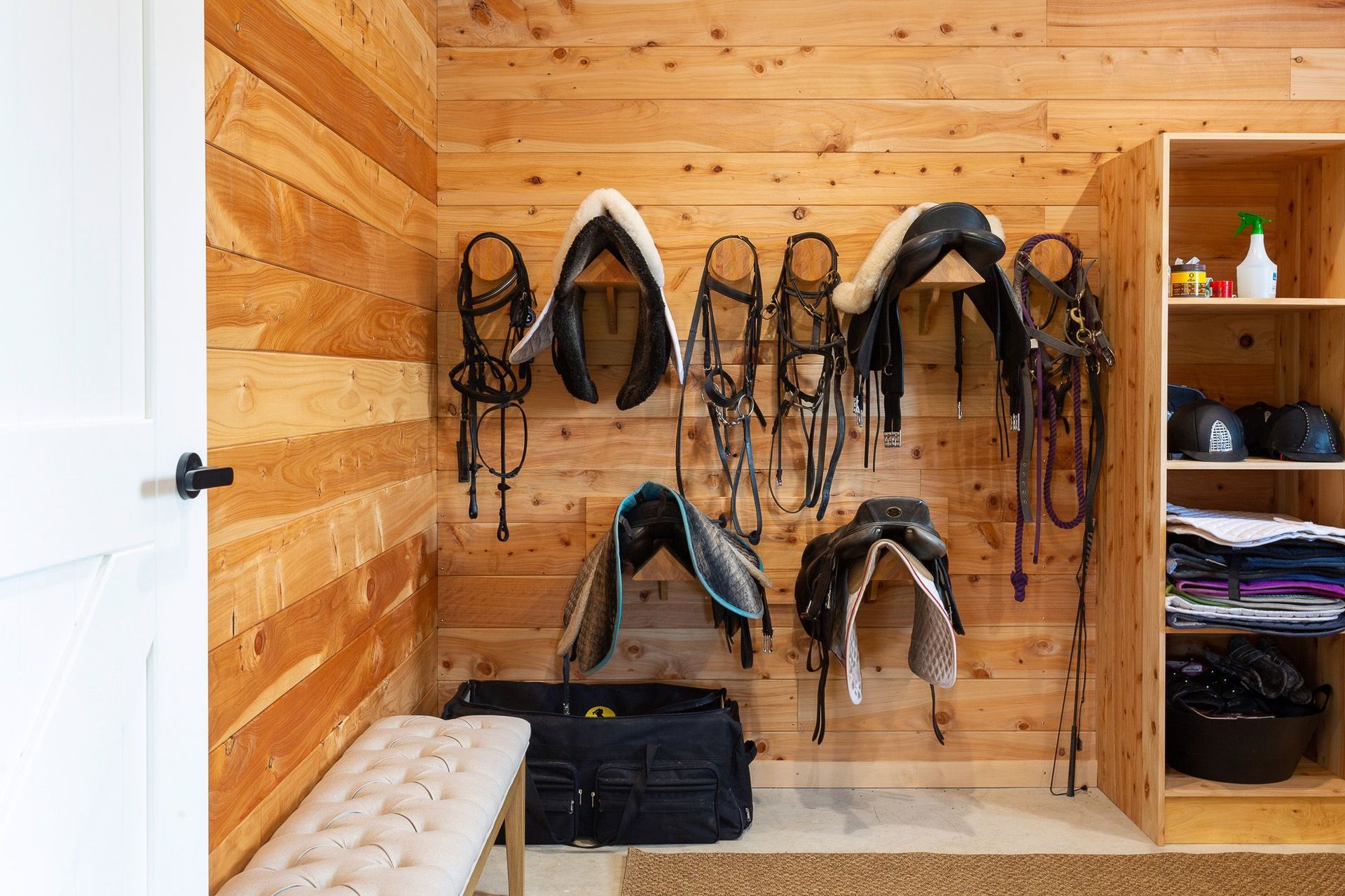 The separate tack room features custom made joinery for housing specialist equestrine gear. 