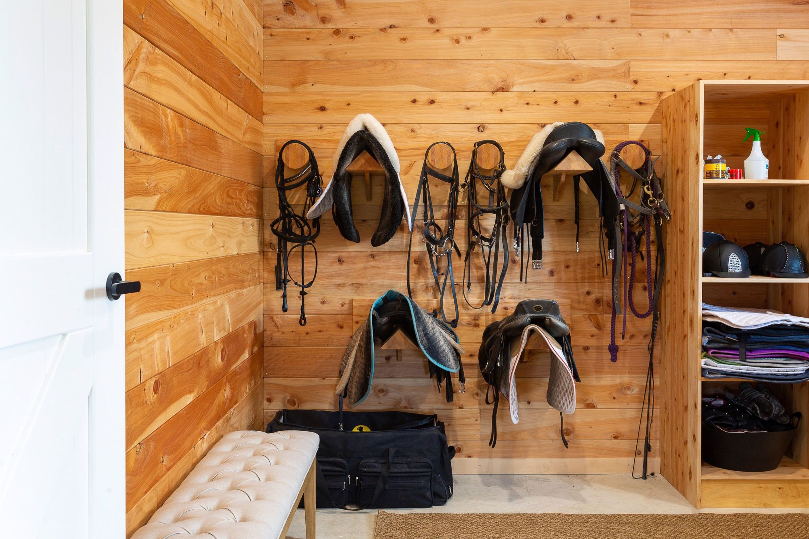 The separate tack room features custom made joinery for housing specialist equestrine gear. 