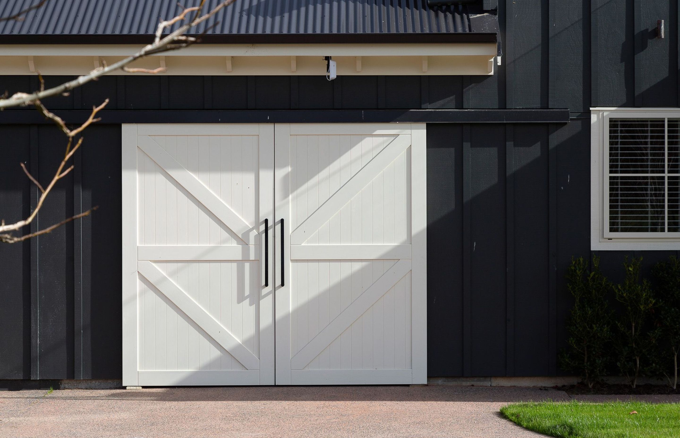 White sliding barn doors enclose the horse stable.