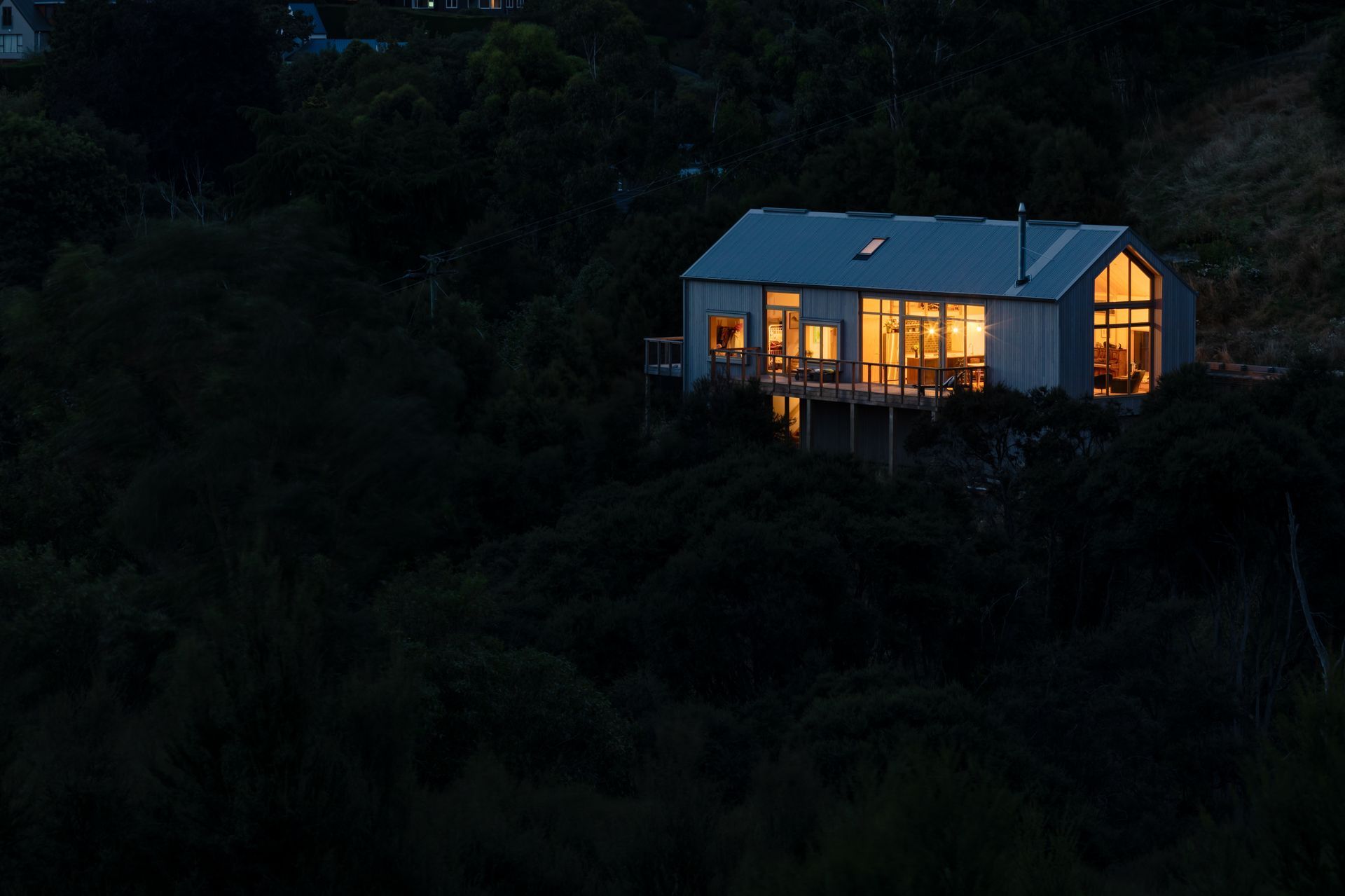 Nestled into the hillside, the form and layout of the house works with the slope and contour of the hill.