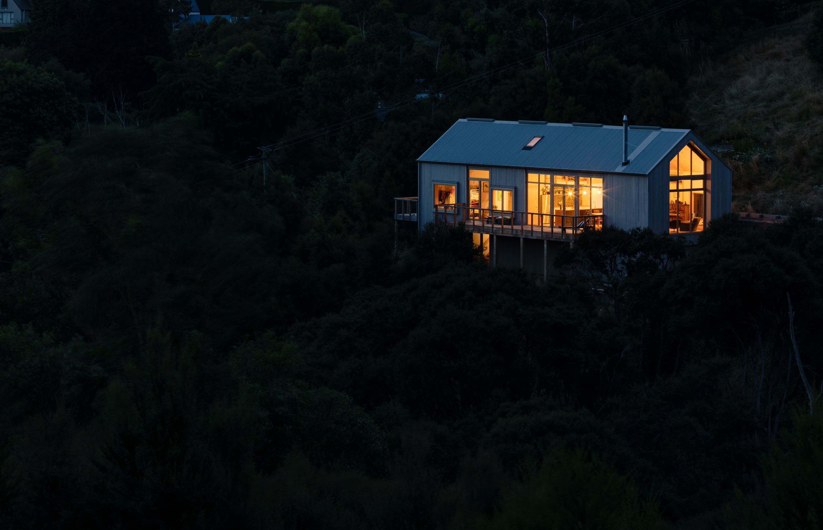 Nestled into the hillside, the form and layout of the house works with the slope and contour of the hill.