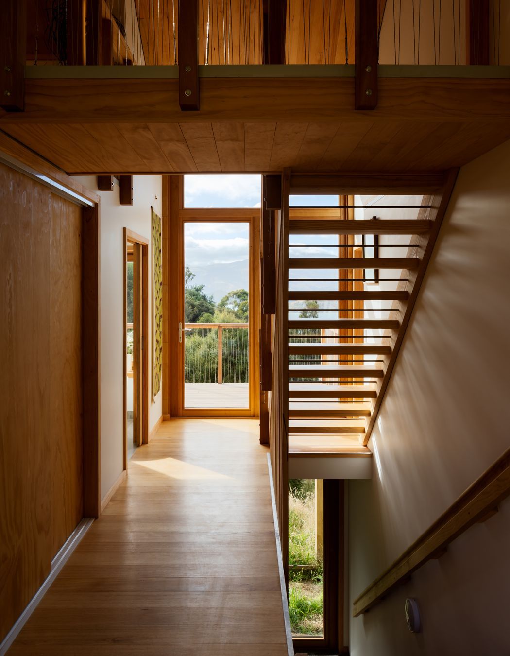 The timber staircase to the mezzanine adds to the house's overall sense of openness.
