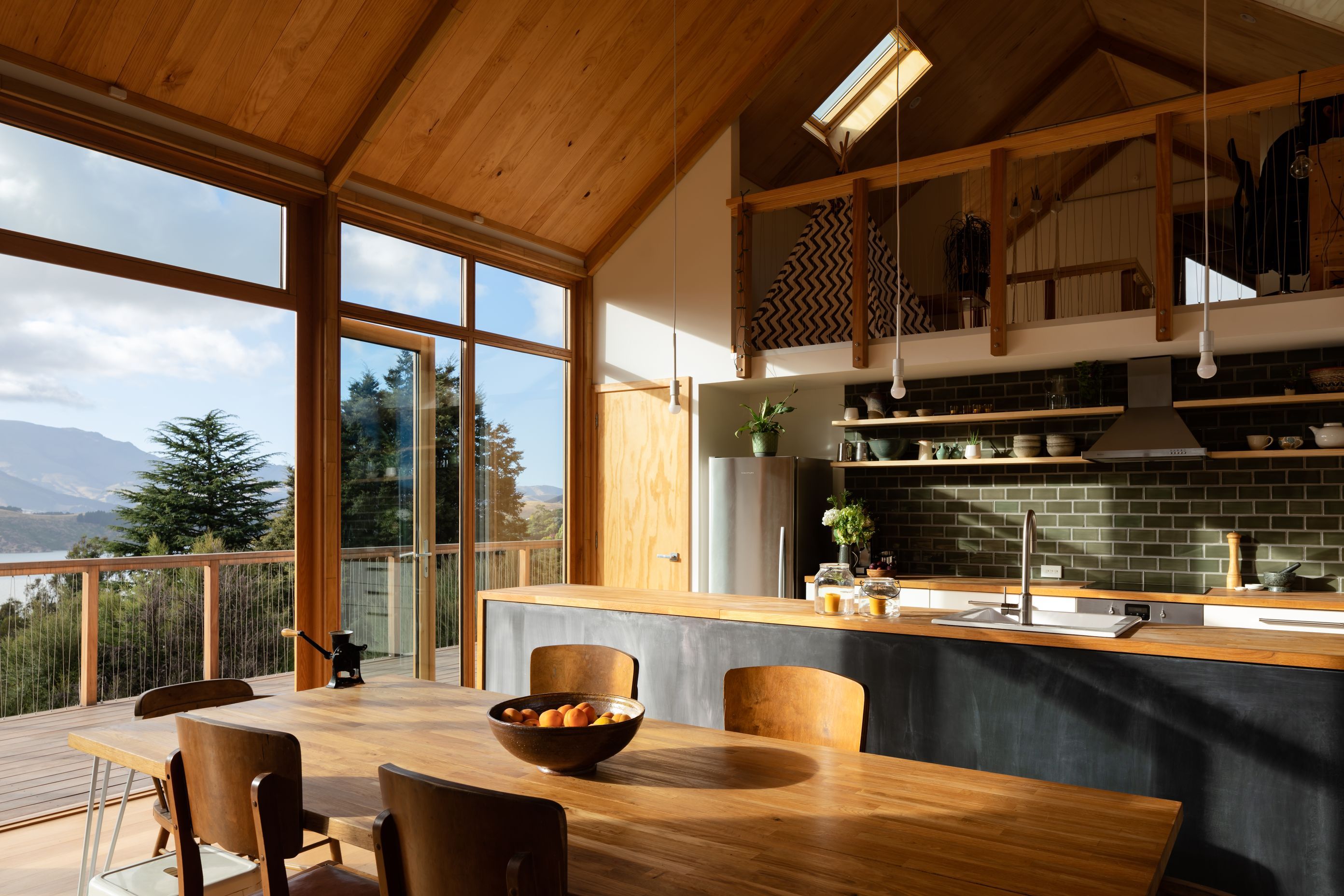 The kitchen sits beneath a mezzanine study and children's play area.