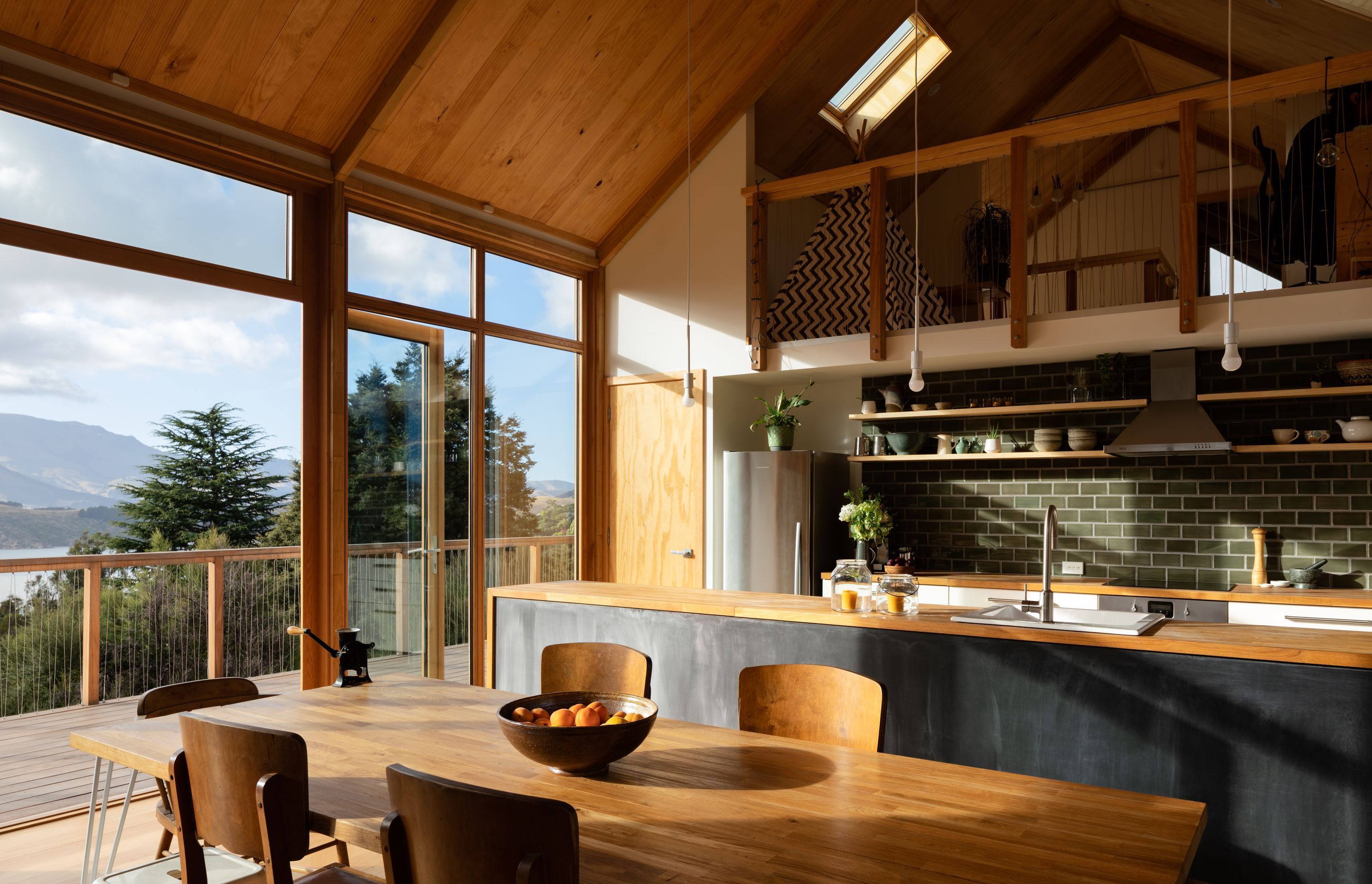 The kitchen sits beneath a mezzanine study and children's play area.