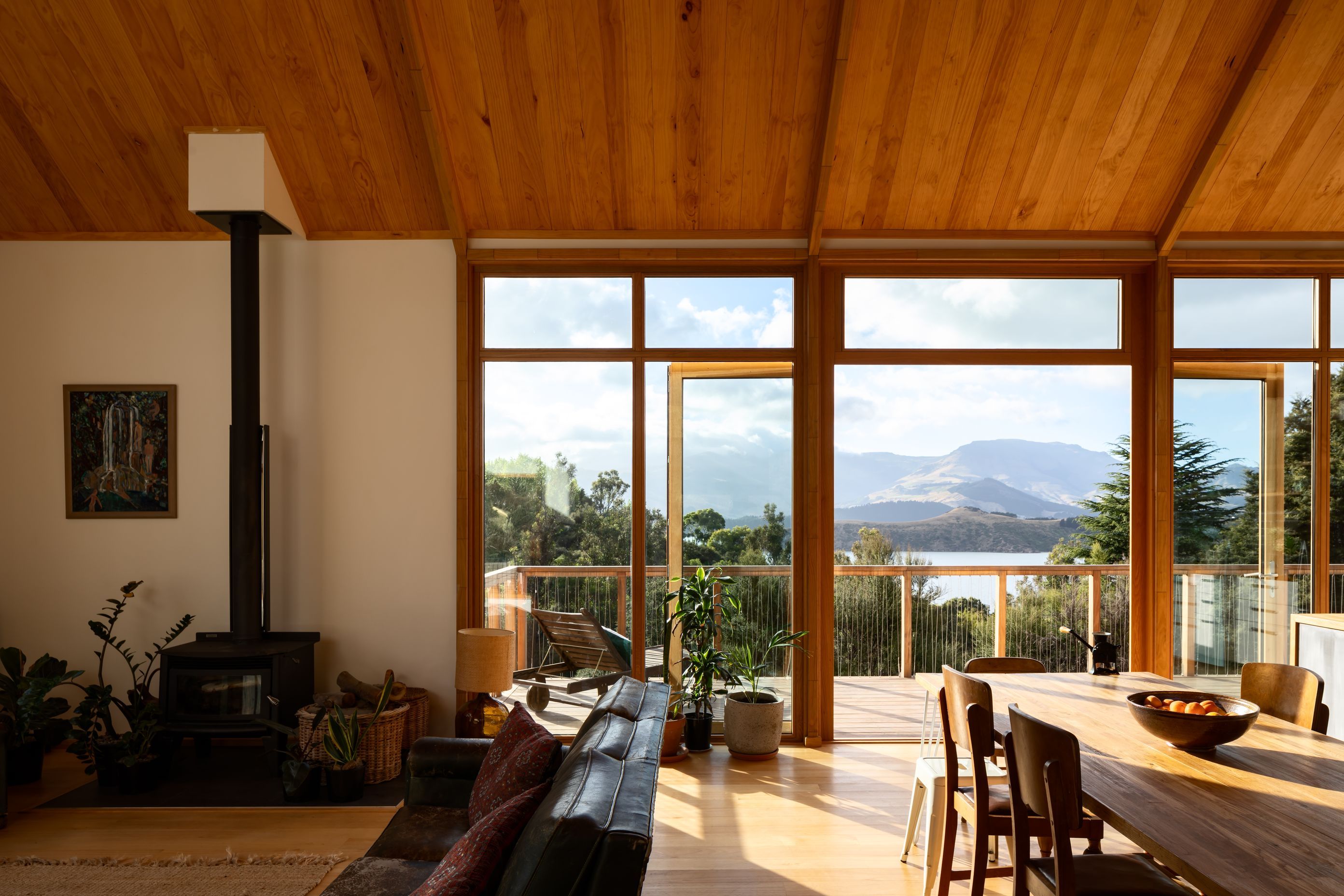 The open-plan living and dining area opens out to a decked area facing the bay. 