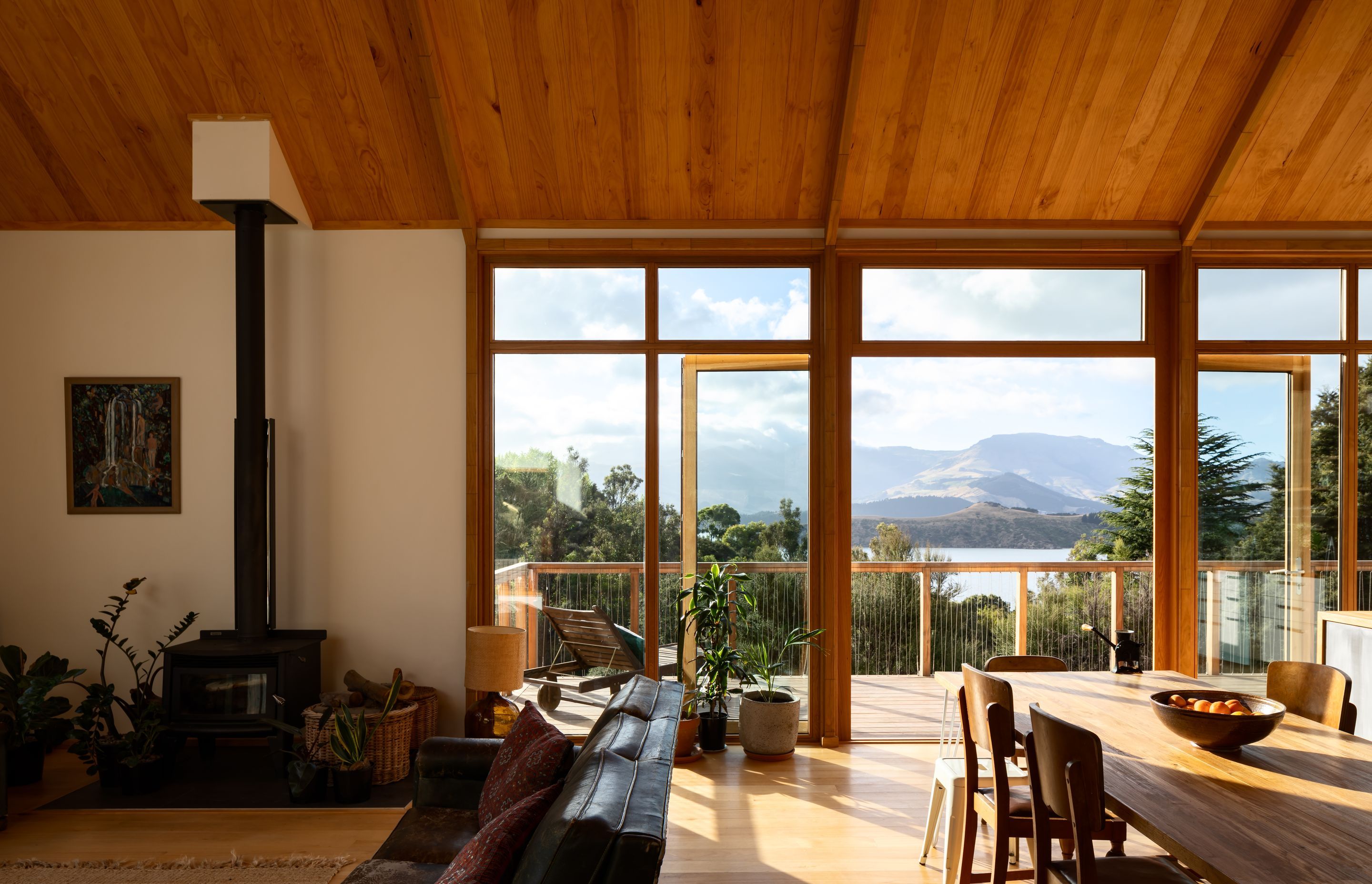 The open-plan living and dining area opens out to a decked area facing the bay. 