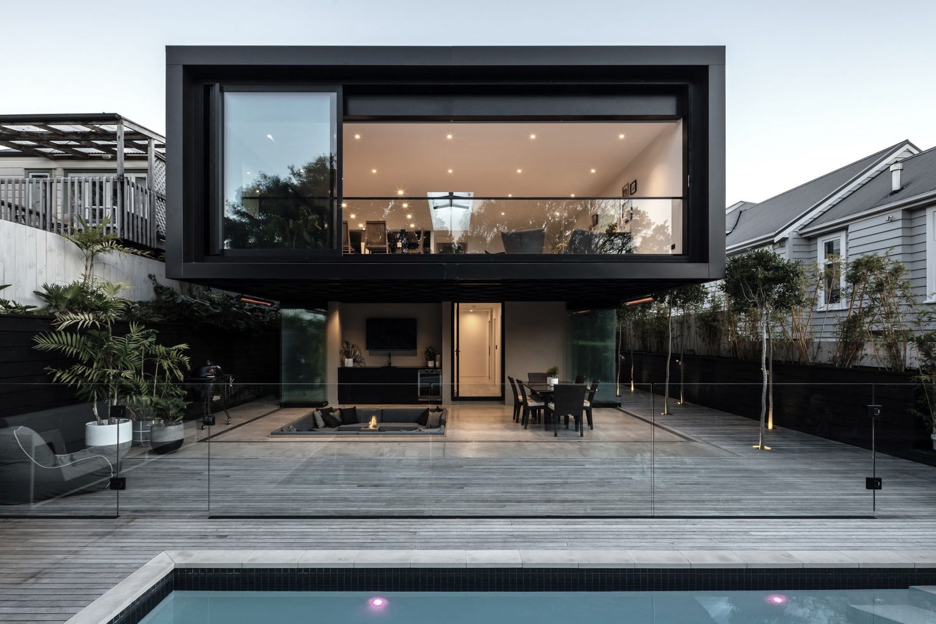 The two-storey extension features an open-plan living area upstairs and a covered outdoor area leading onto a newly installed swimming pool.