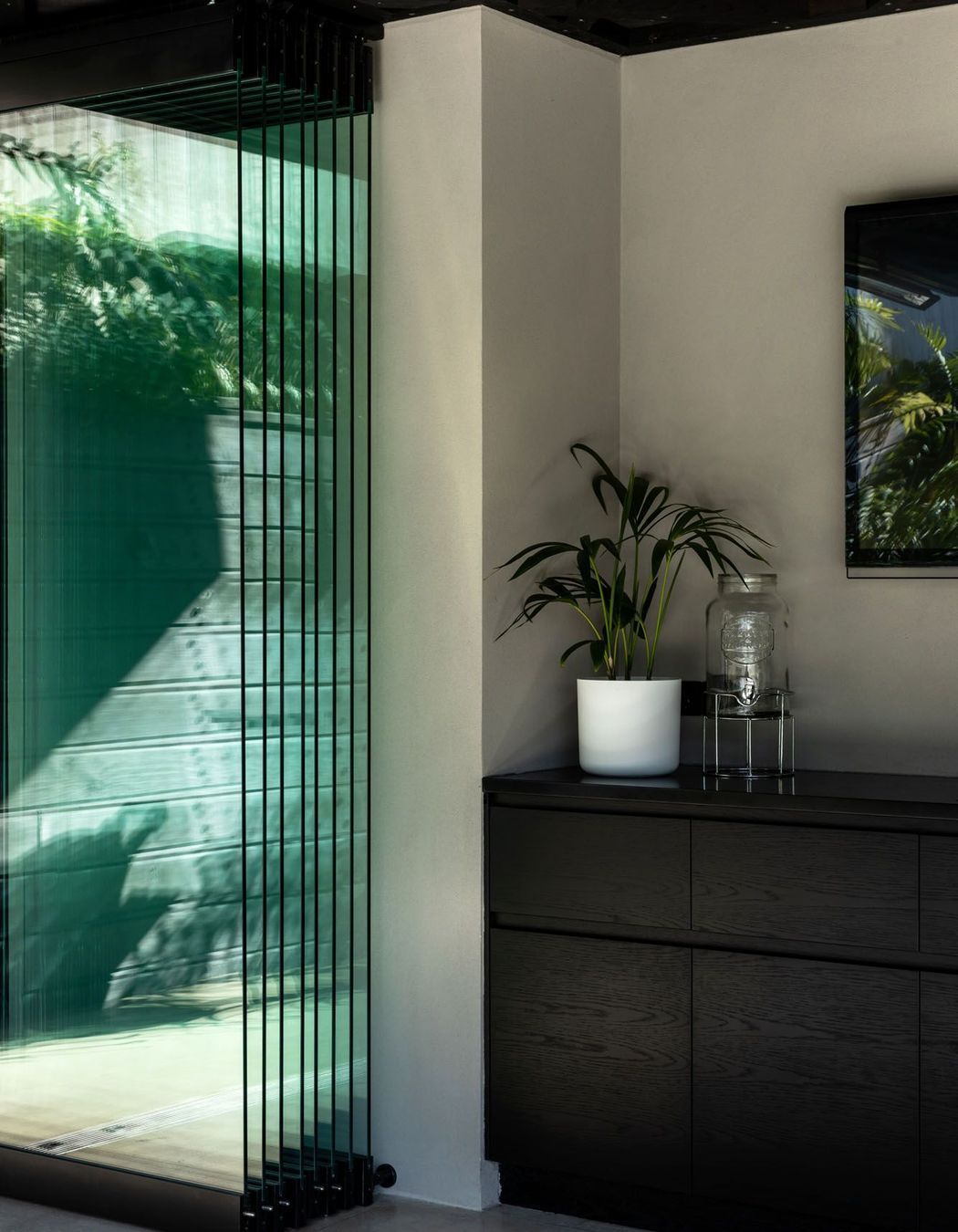 Stacking glass doors can be used to completely enclose the outdoor area, effectively turning it into a second lounge.