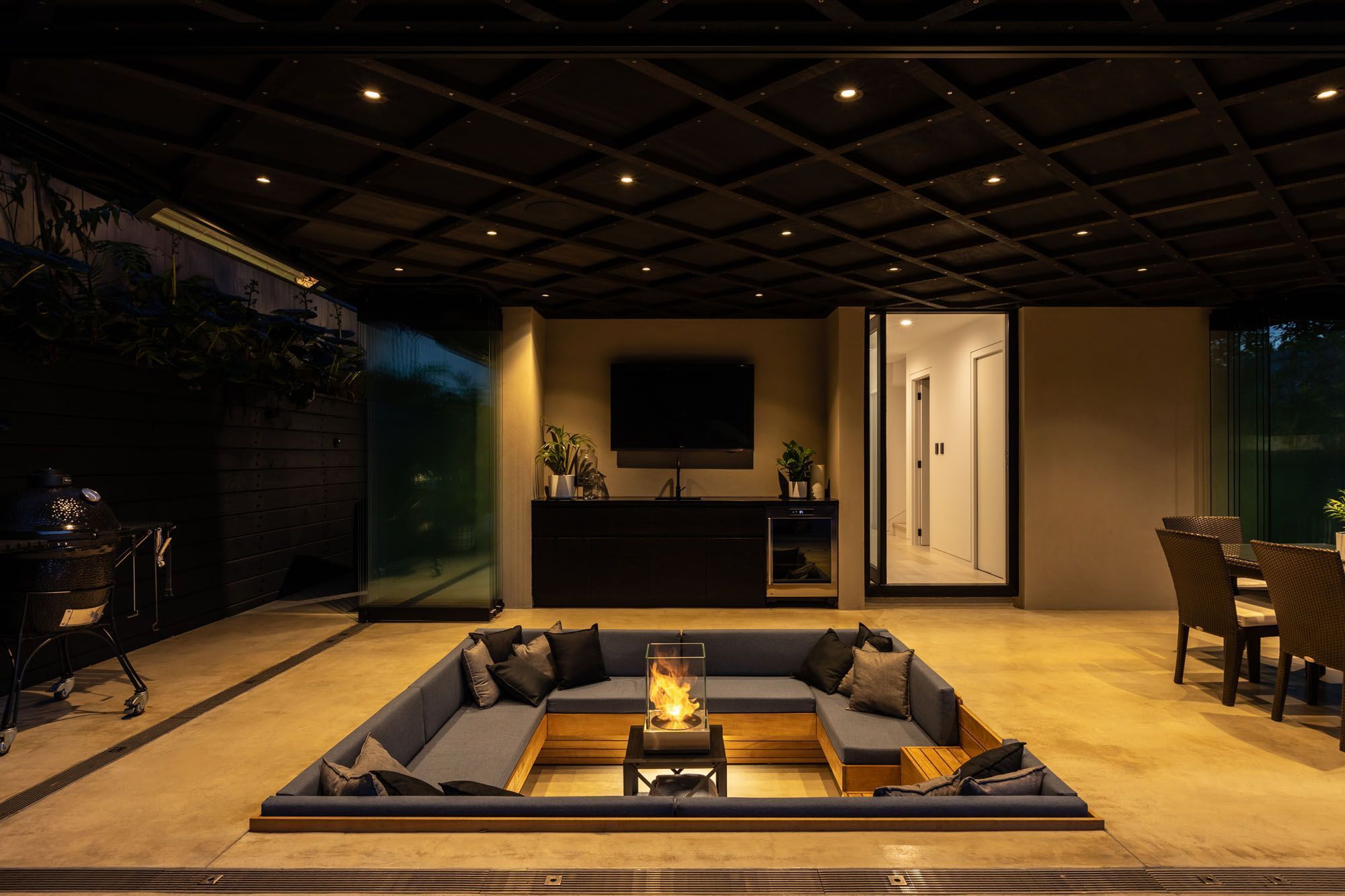 A conversation/fire pit is the centrepiece of the outdoor area, which can be completely enclosed with glass stacking doors.