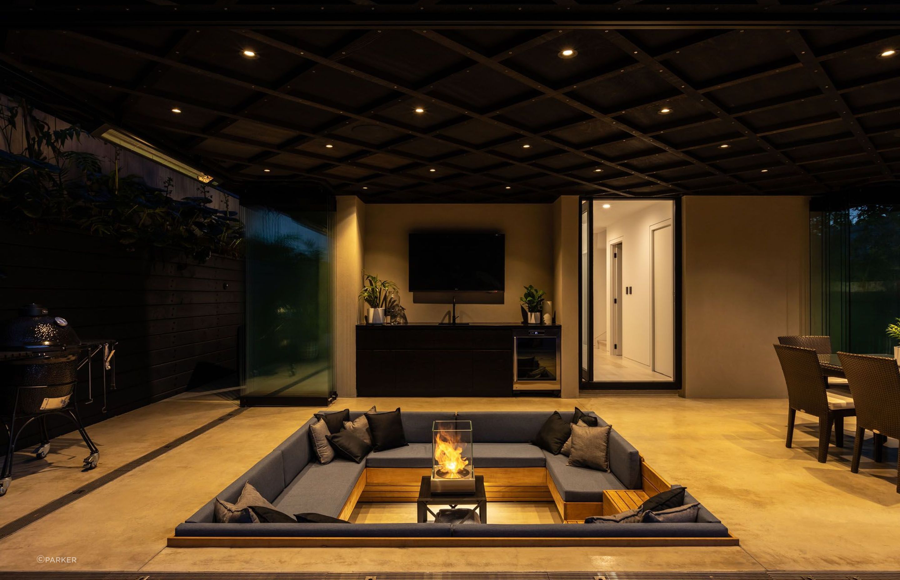 A conversation/fire pit is the centrepiece of the outdoor area, which can be completely enclosed with glass stacking doors.