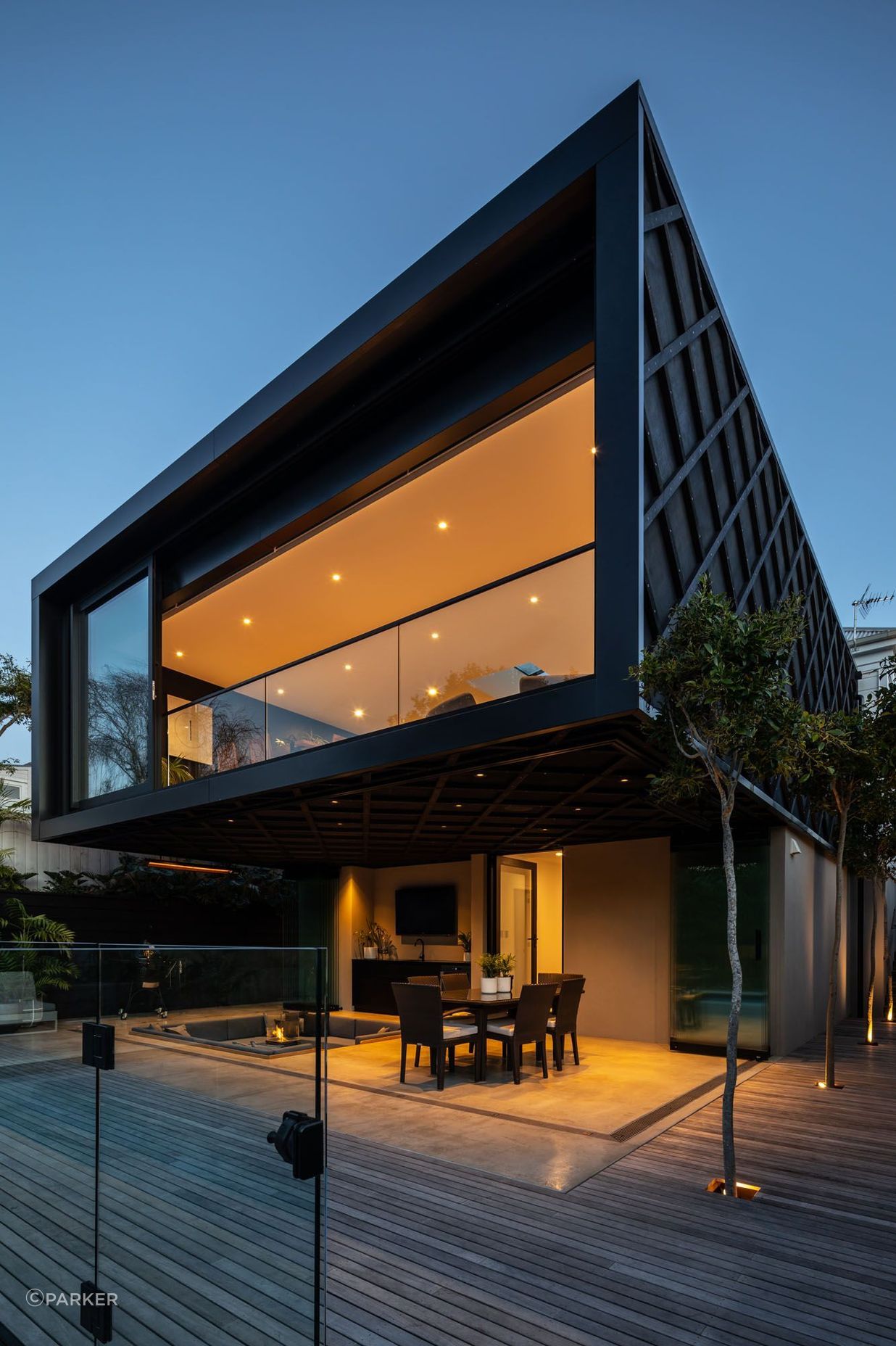 Dark stained Western Red Cedar cladding with criss-cross detailing demarcates the new extension from the original villa.