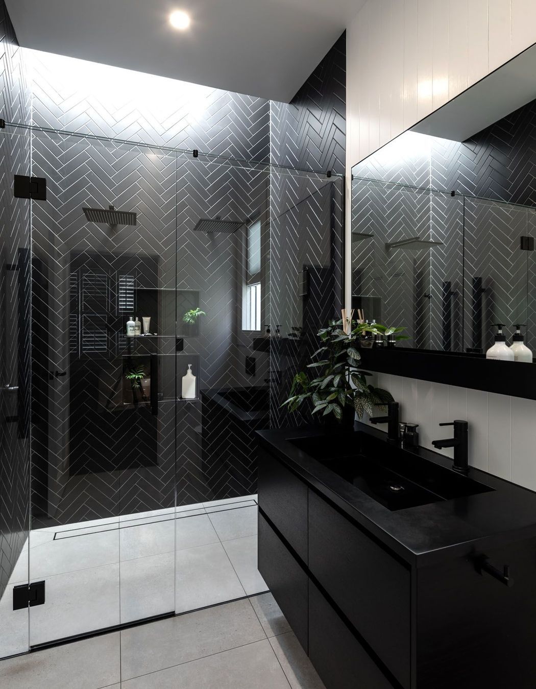 The black and white colour scheme is fully realised in the bathrooms.