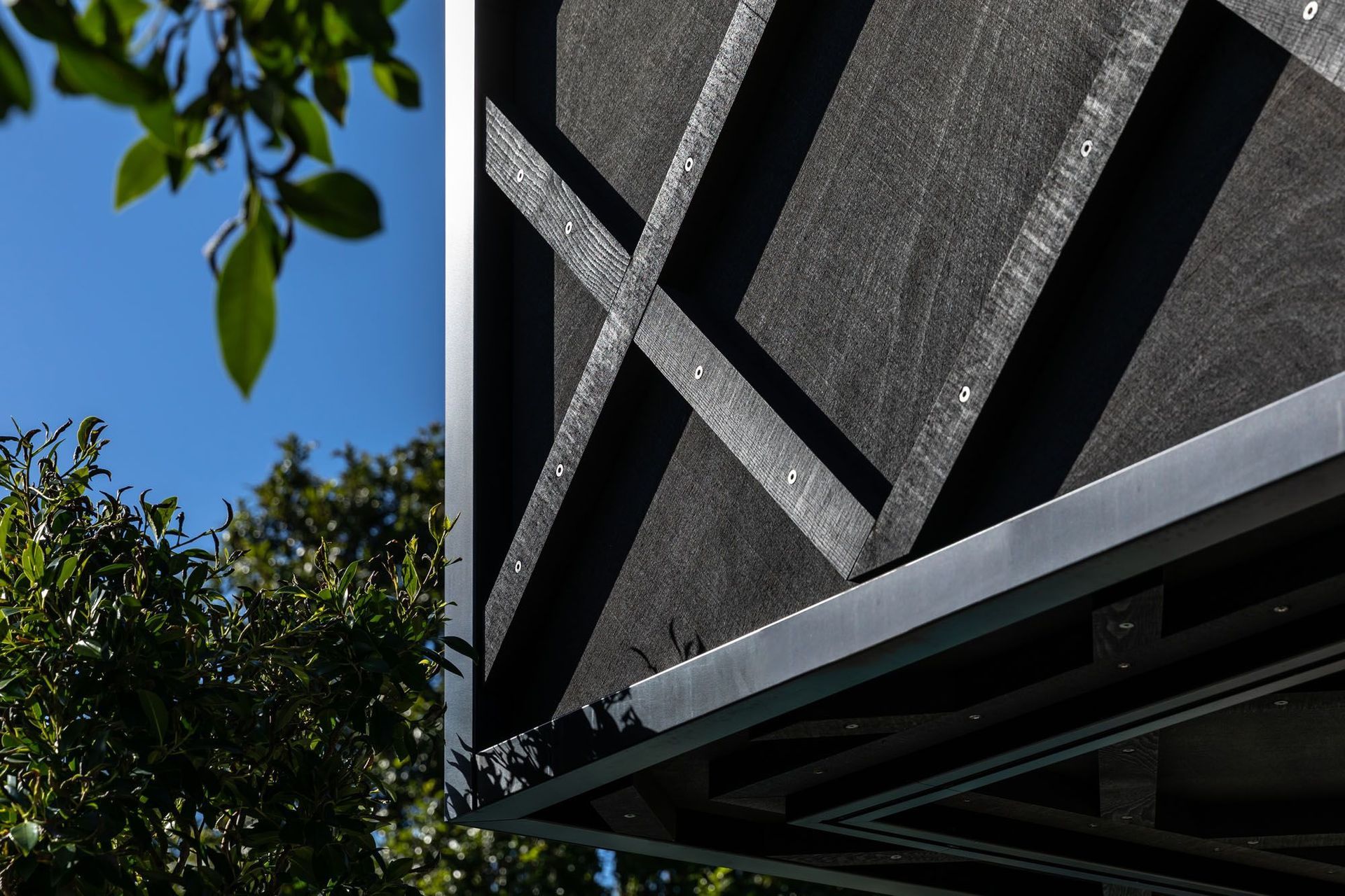 The architects to their cue for the extension's cladding detail from the original villa's weatherboards, turning the horizontal lines 45 degrees.