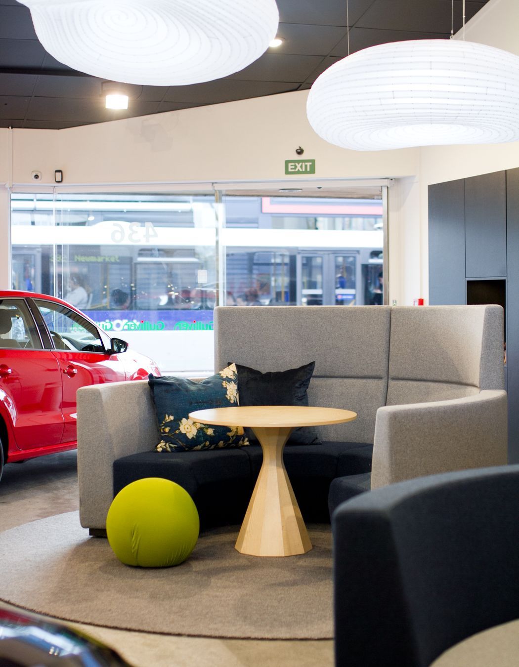 Fletcher Design Realm seating systems covered in pure New Zealand wool by Camira Fabrics add a warm foil to the hardness of the shiny vehicles.