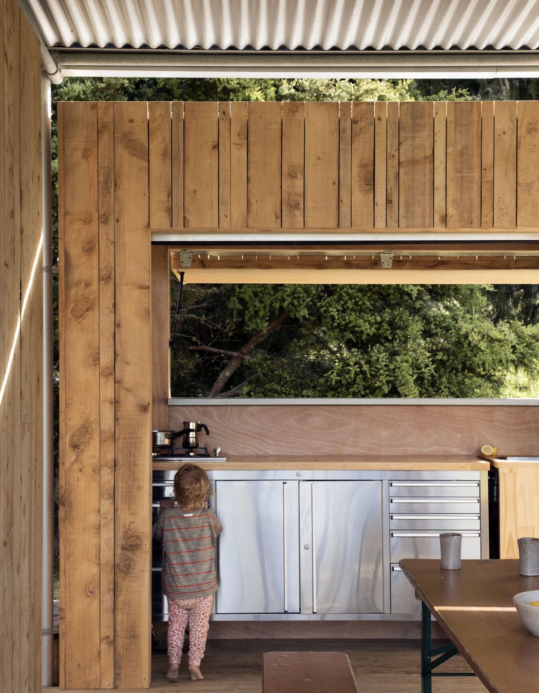 The kitchen cabinetry is an off-the-shelf tool bench with a sink cut out of the top.