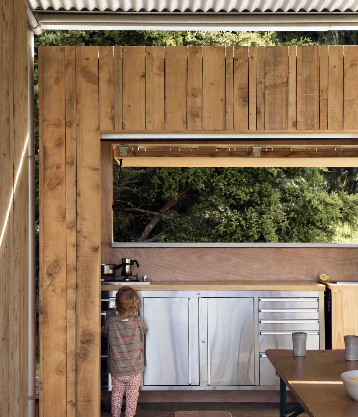 The kitchen cabinetry is an off-the-shelf tool bench with a sink cut out of the top.