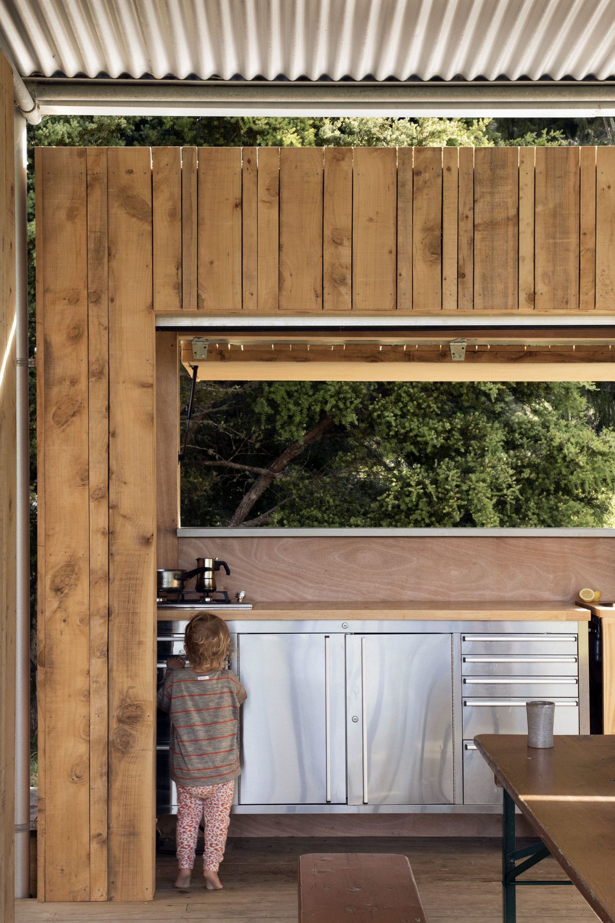 The kitchen cabinetry is an off-the-shelf tool bench with a sink cut out of the top.