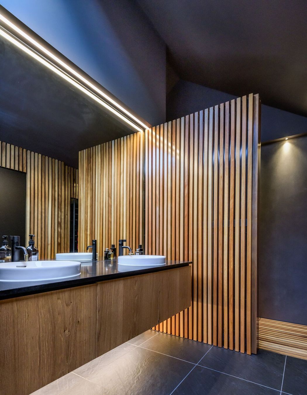LED lights and a skylight add drama to the ensuite bathroom.