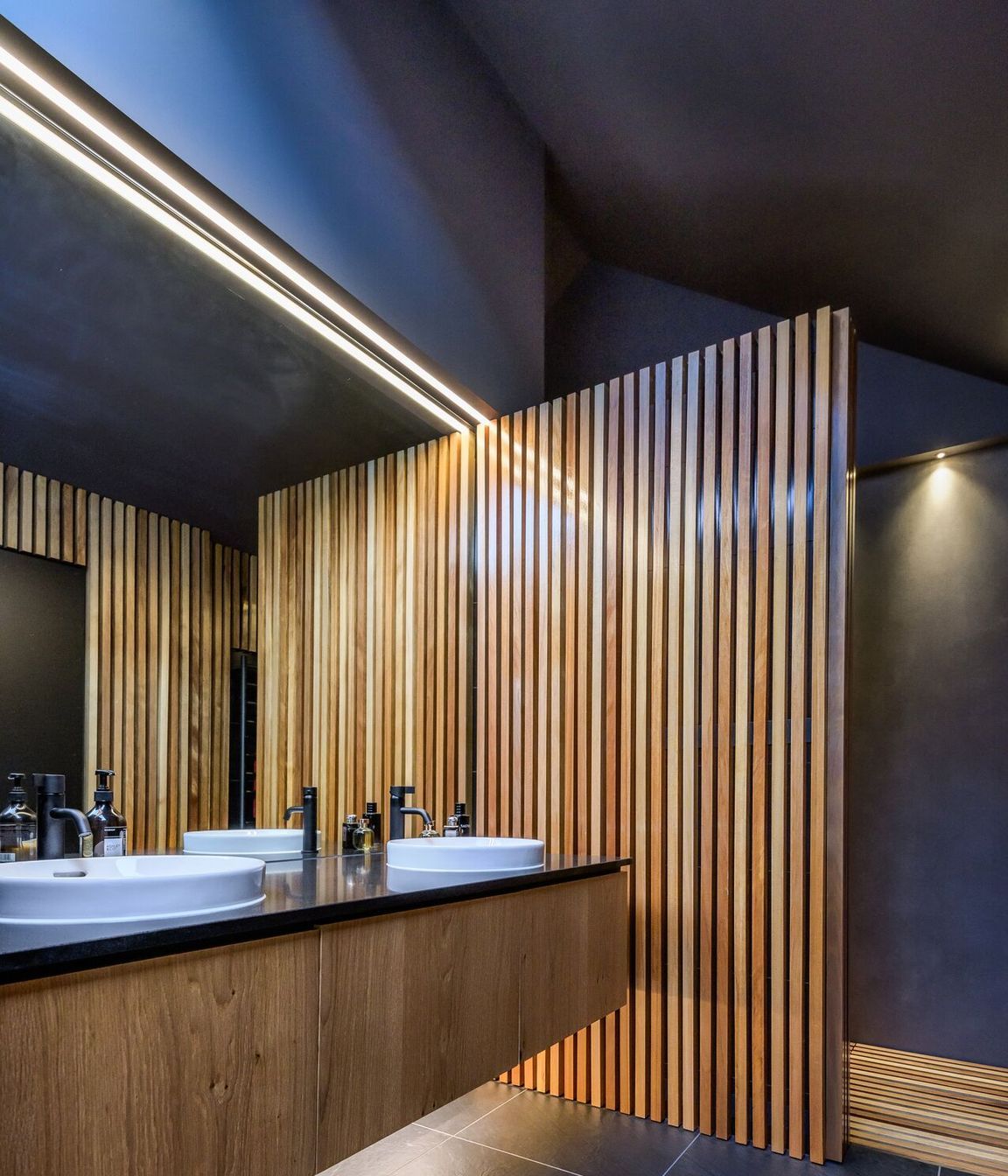 LED lights and a skylight add drama to the ensuite bathroom.
