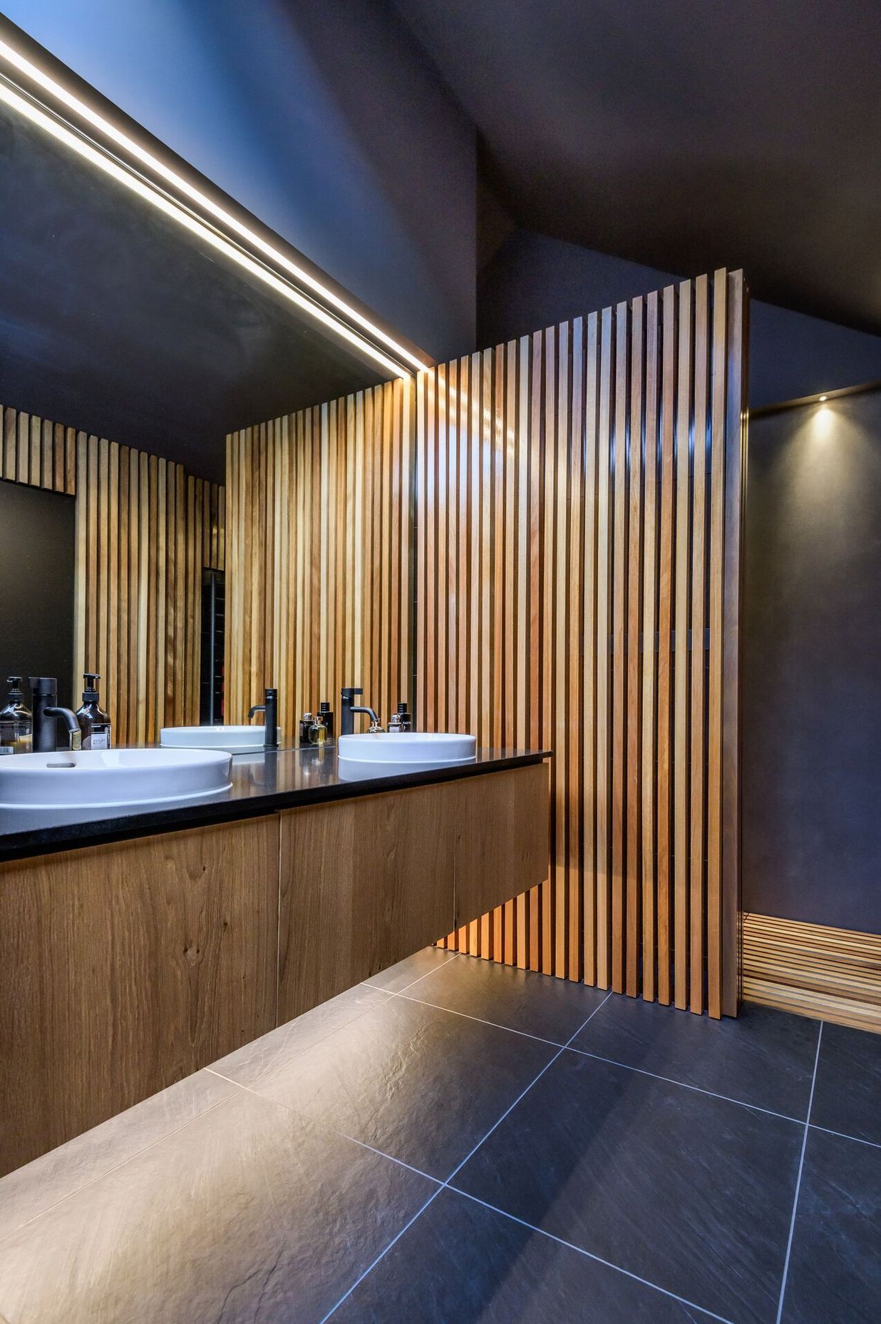 LED lights and a skylight add drama to the ensuite bathroom.