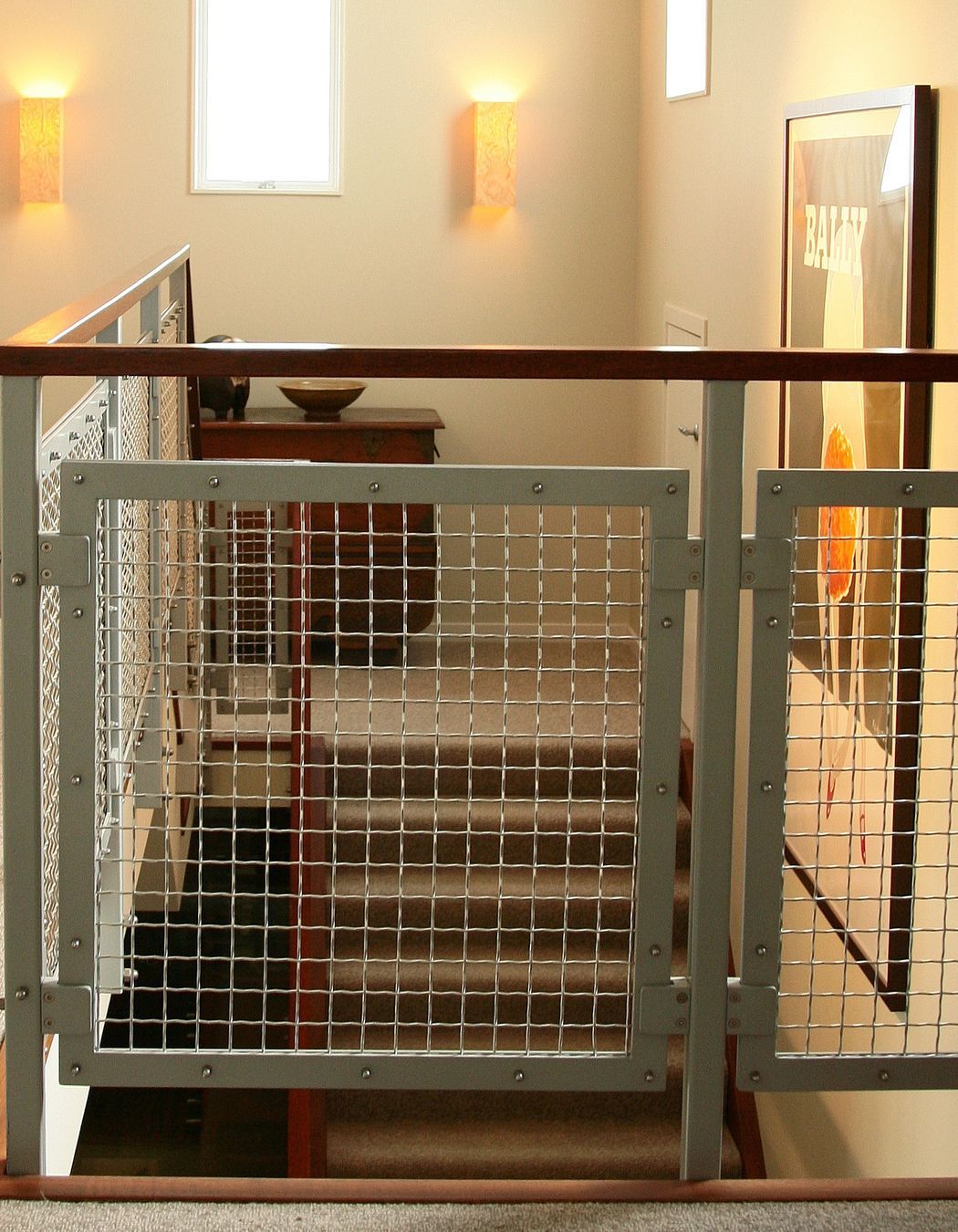 Staircase stringer and handrail link to the strong-coloured Merbau floorboards downstairs