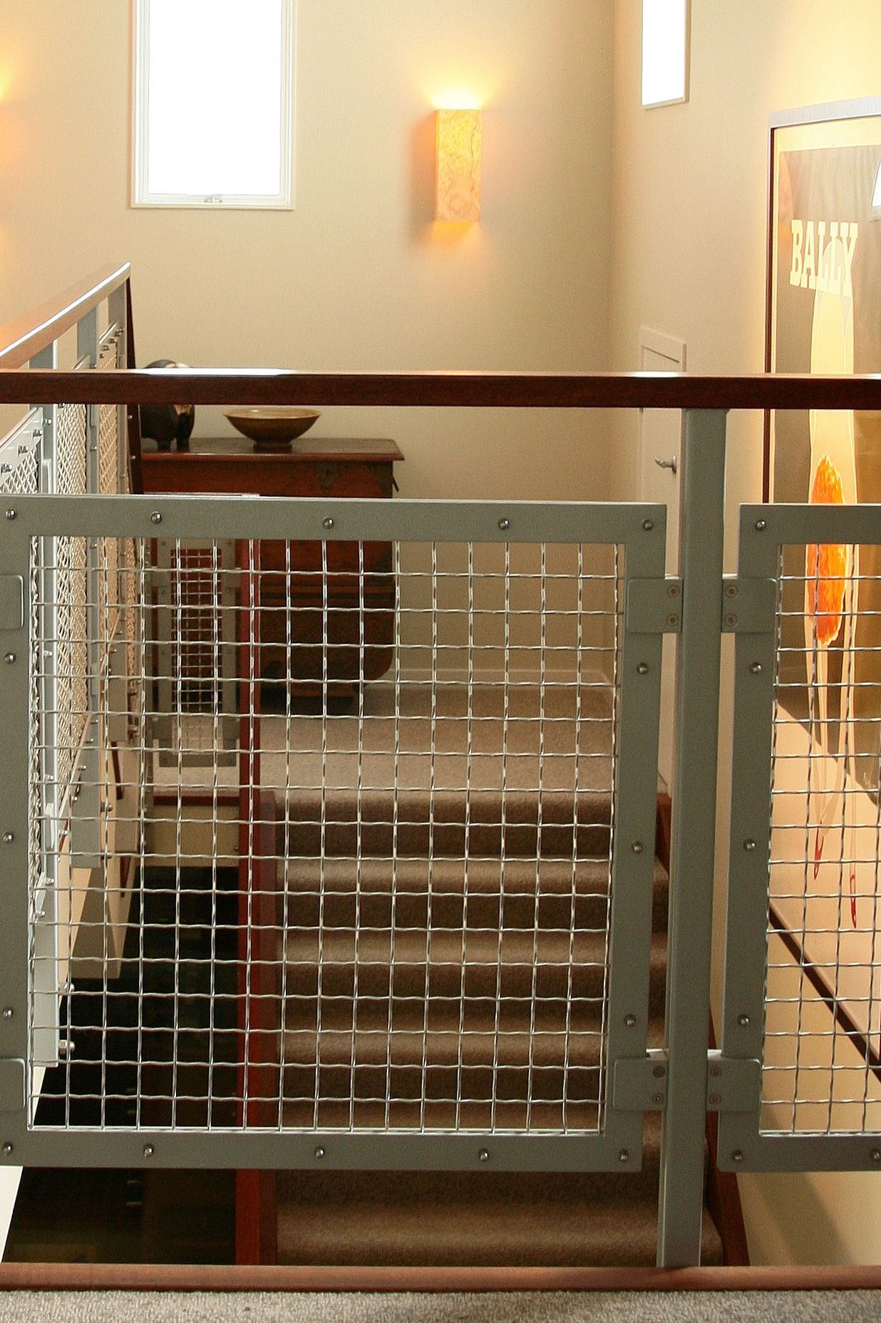 Staircase stringer and handrail link to the strong-coloured Merbau floorboards downstairs