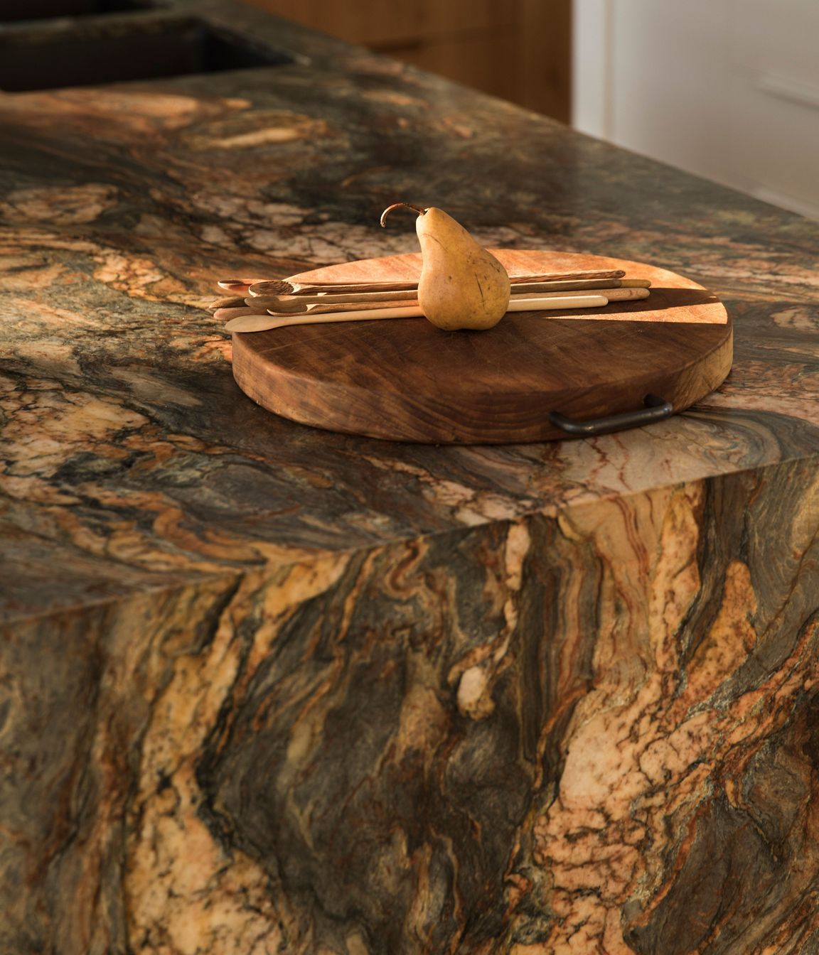 Rich warm tones and patterns can be seen in the quartzite stone kitchen island.