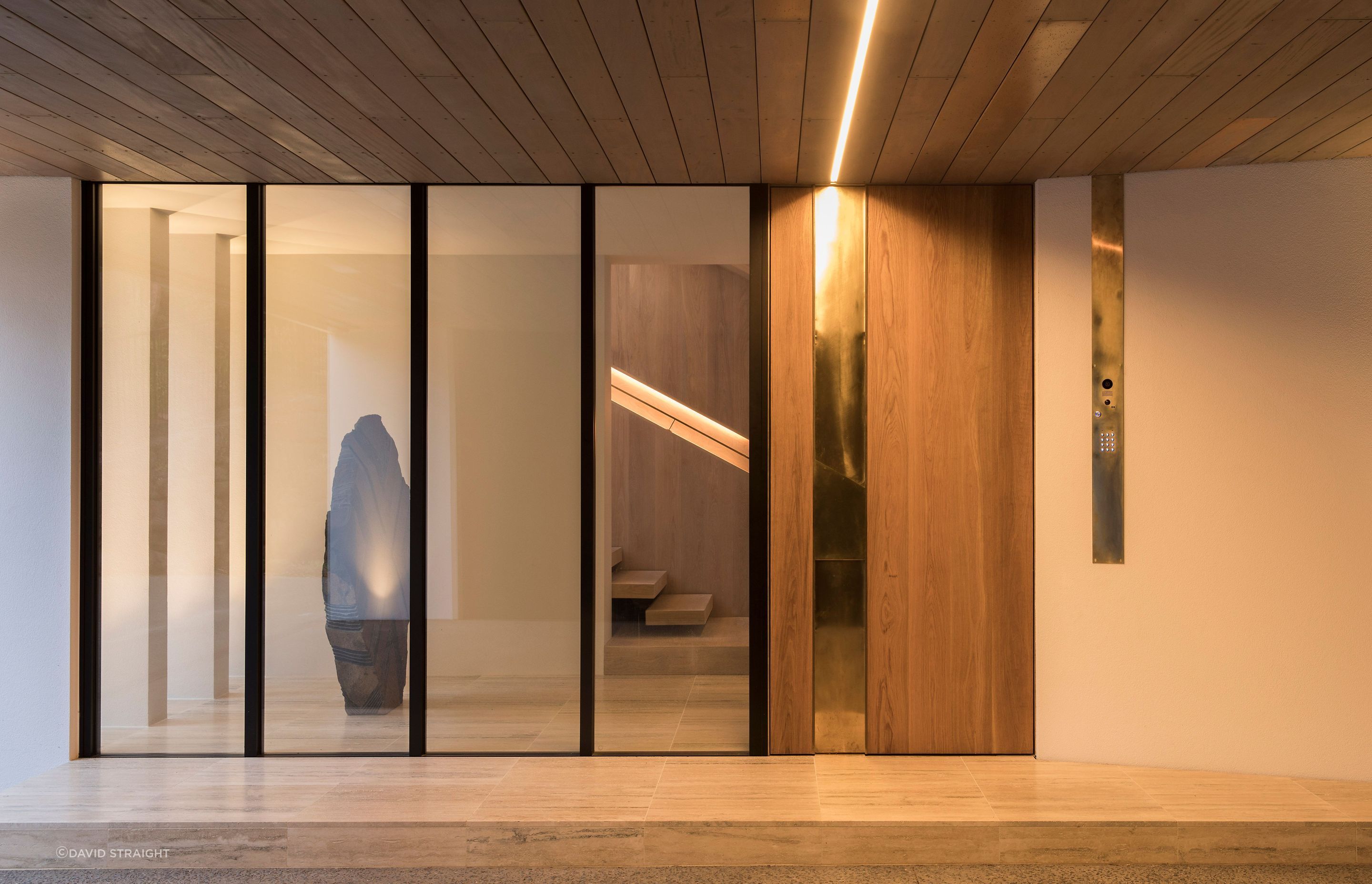 The front entrance looks into a gallery-like atrium with travertine florring.