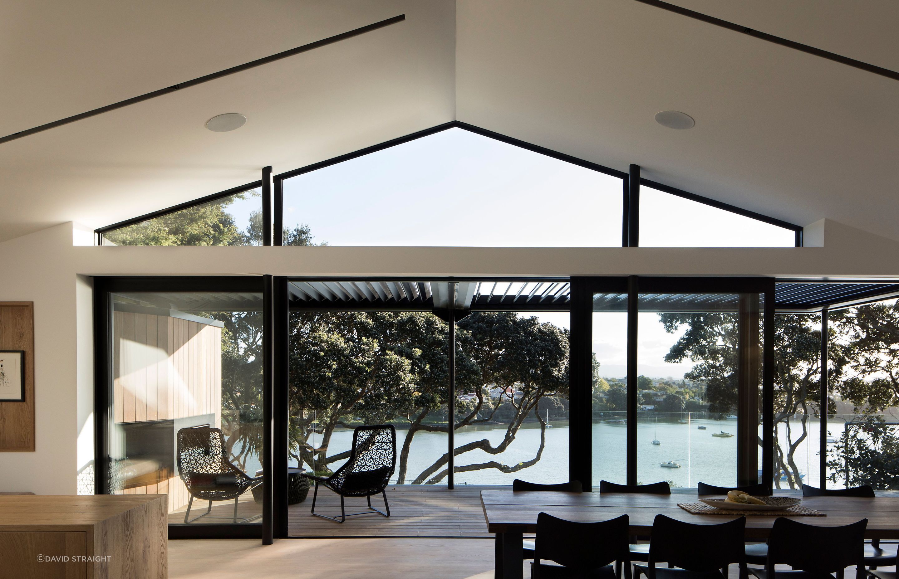 In the living spaces, the ceiling of the existing brick-and-tile home has been raised to create a triangular clerestory windows that opens up the volume and adds light and shadow.