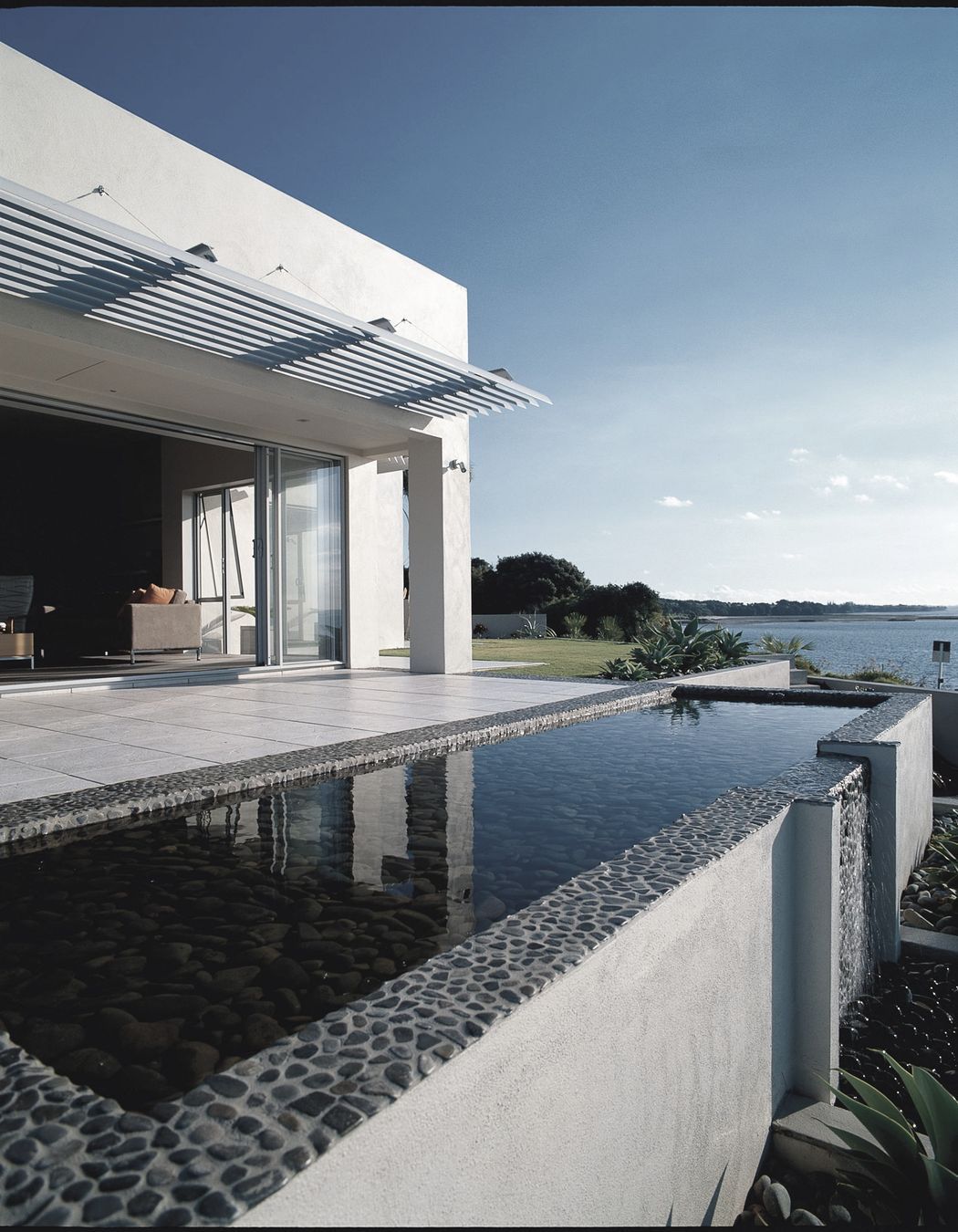 Water everywhere, the reflecting pool (over a water storage tank) sets up the promontory view to the Hauraki Gulf & Islands