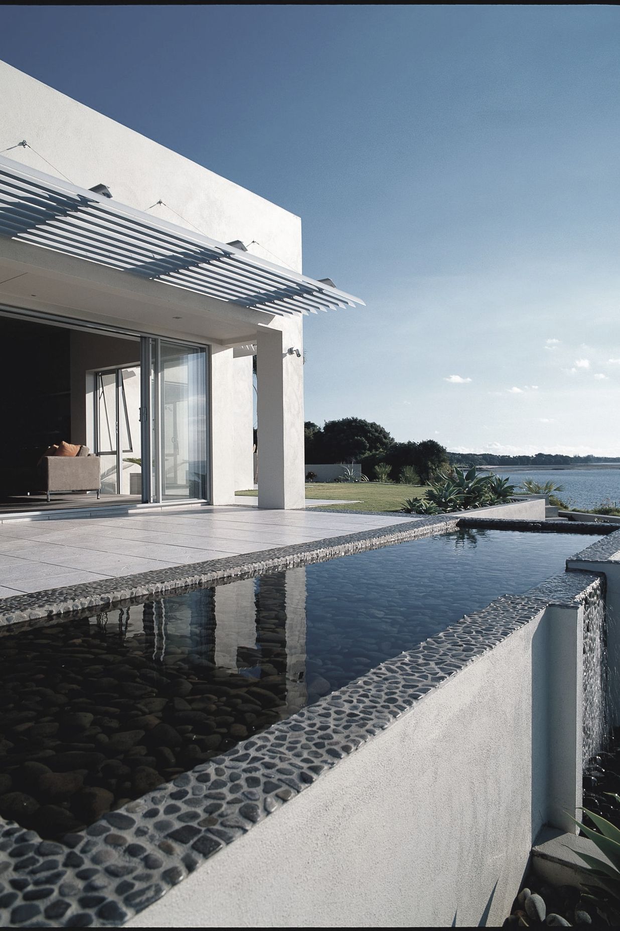 Water everywhere, the reflecting pool (over a water storage tank) sets up the promontory view to the Hauraki Gulf &amp; Islands