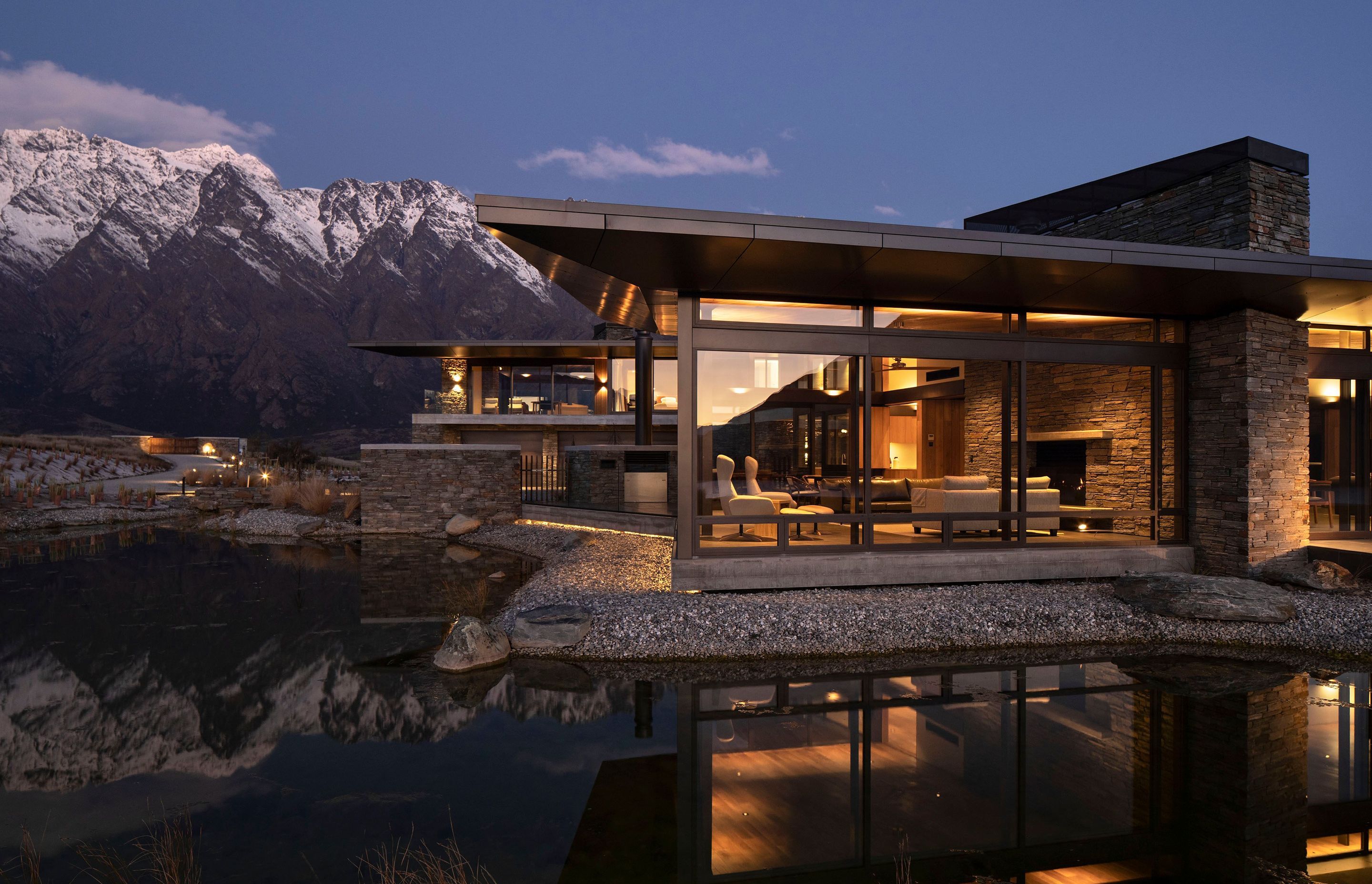 A night view of Hidden Island Retreat sitting beneath the mountains. The main driveway can be seen lit up on the left. Photograph: Simon Devitt.