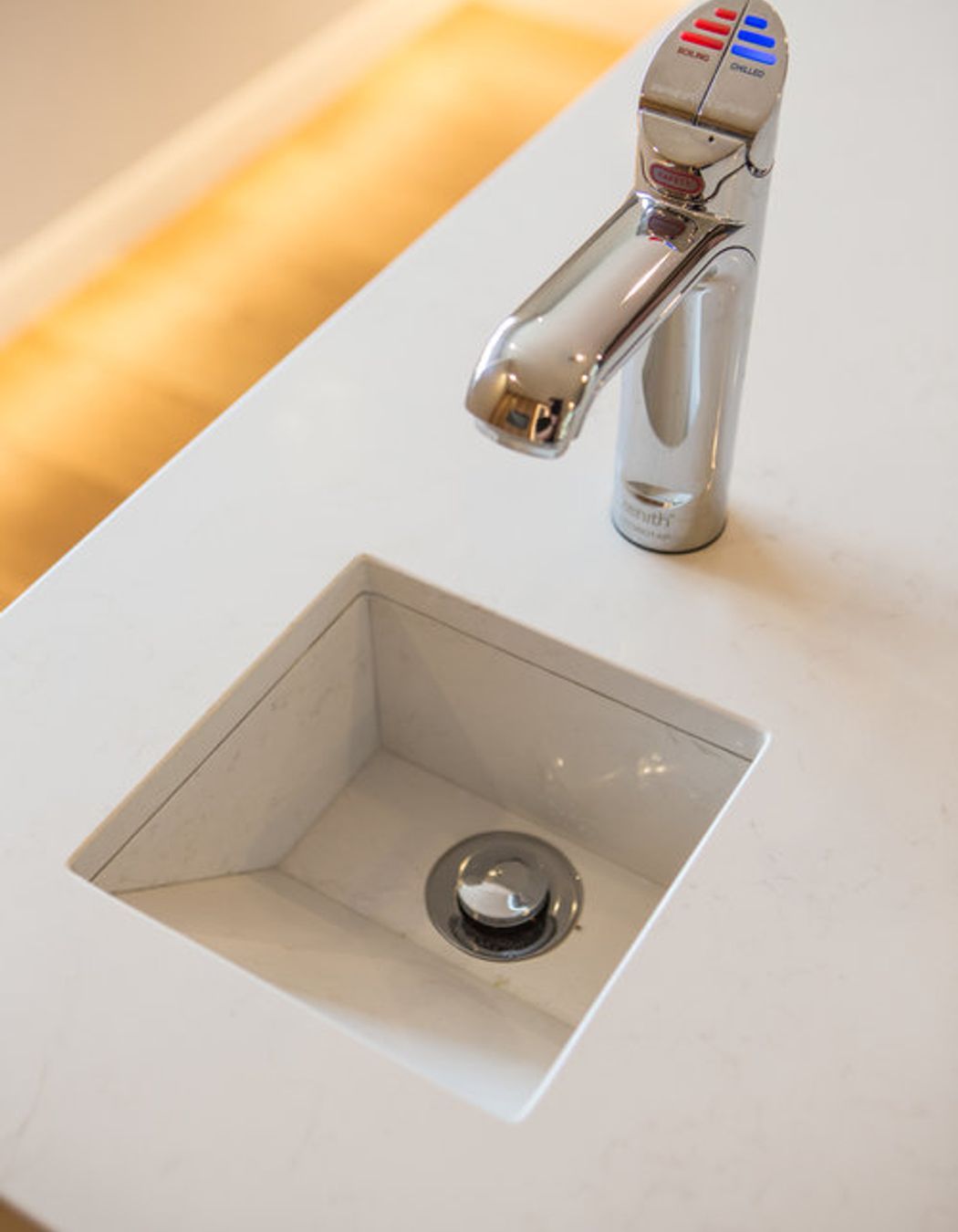 A custom stone drip-sink was designed into the island benchtop to work with a Zenith hydro tap which supplies boiling, filtered, and sparkling water.
