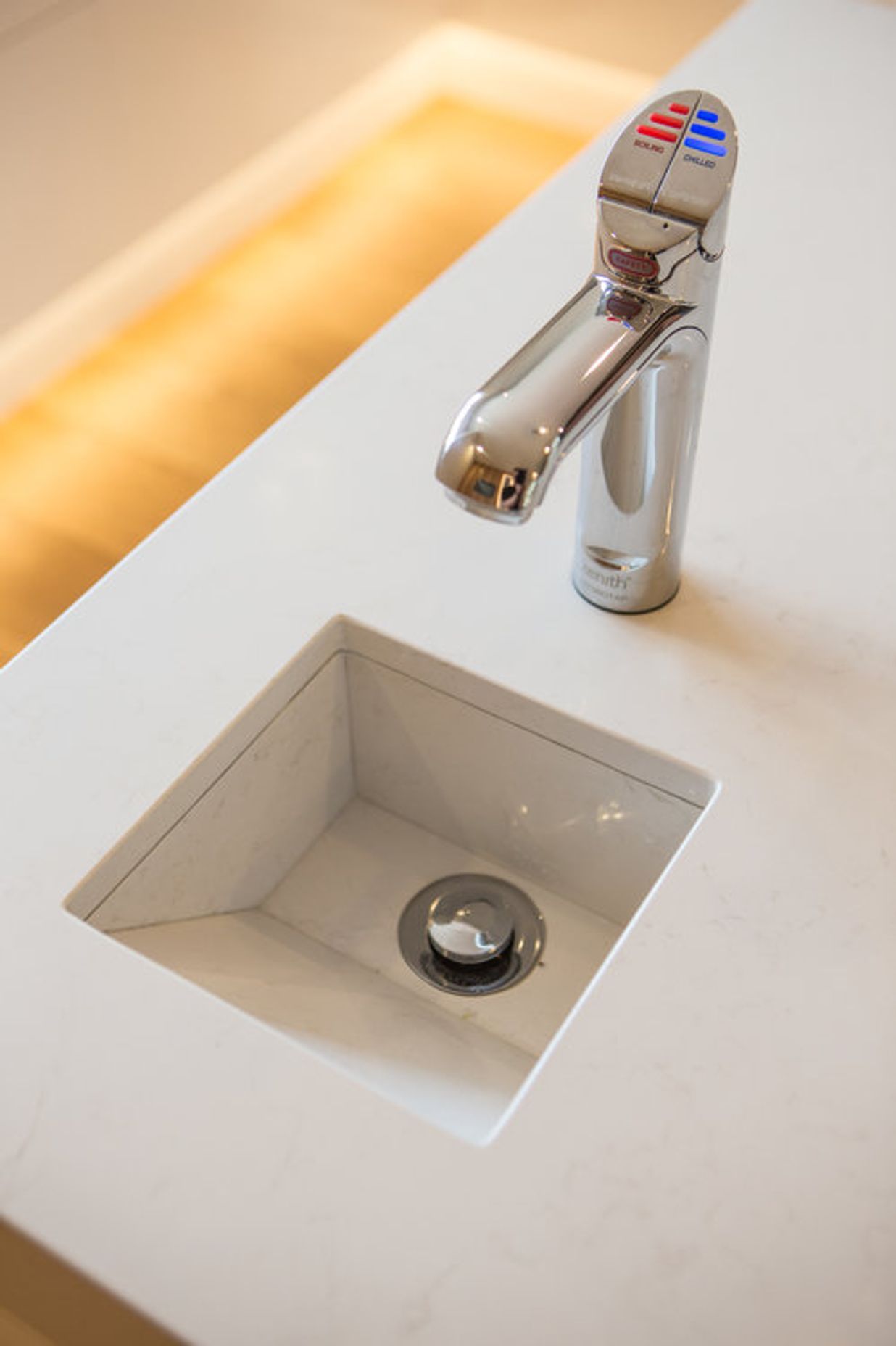 A custom stone drip-sink was designed into the island benchtop to work with a Zenith hydro tap which supplies boiling, filtered, and sparkling water.