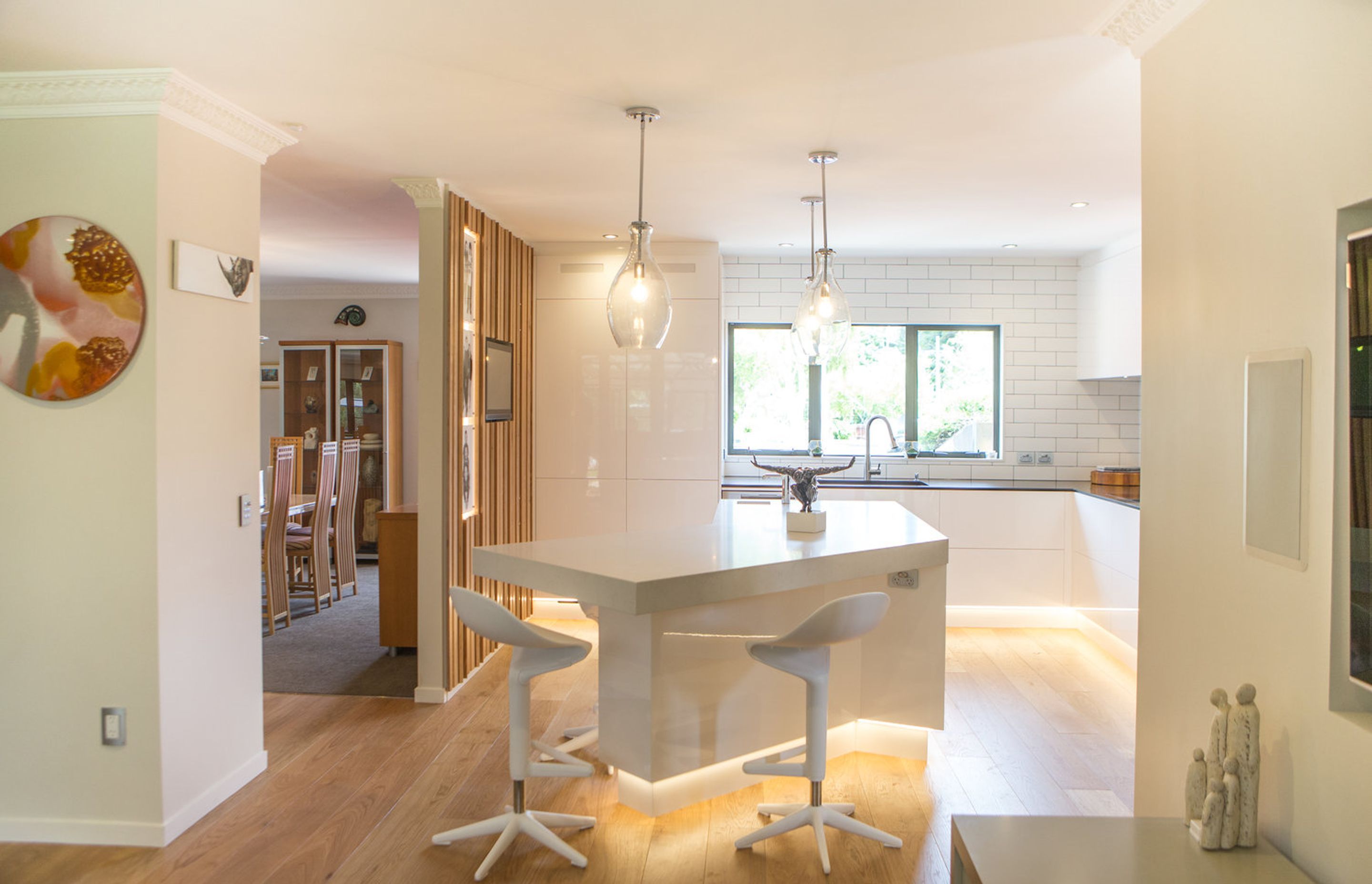 The angled island centres the space, providing a grounding for gatherings and entertaining, as well as drawing people in from the adjacent spaces.
