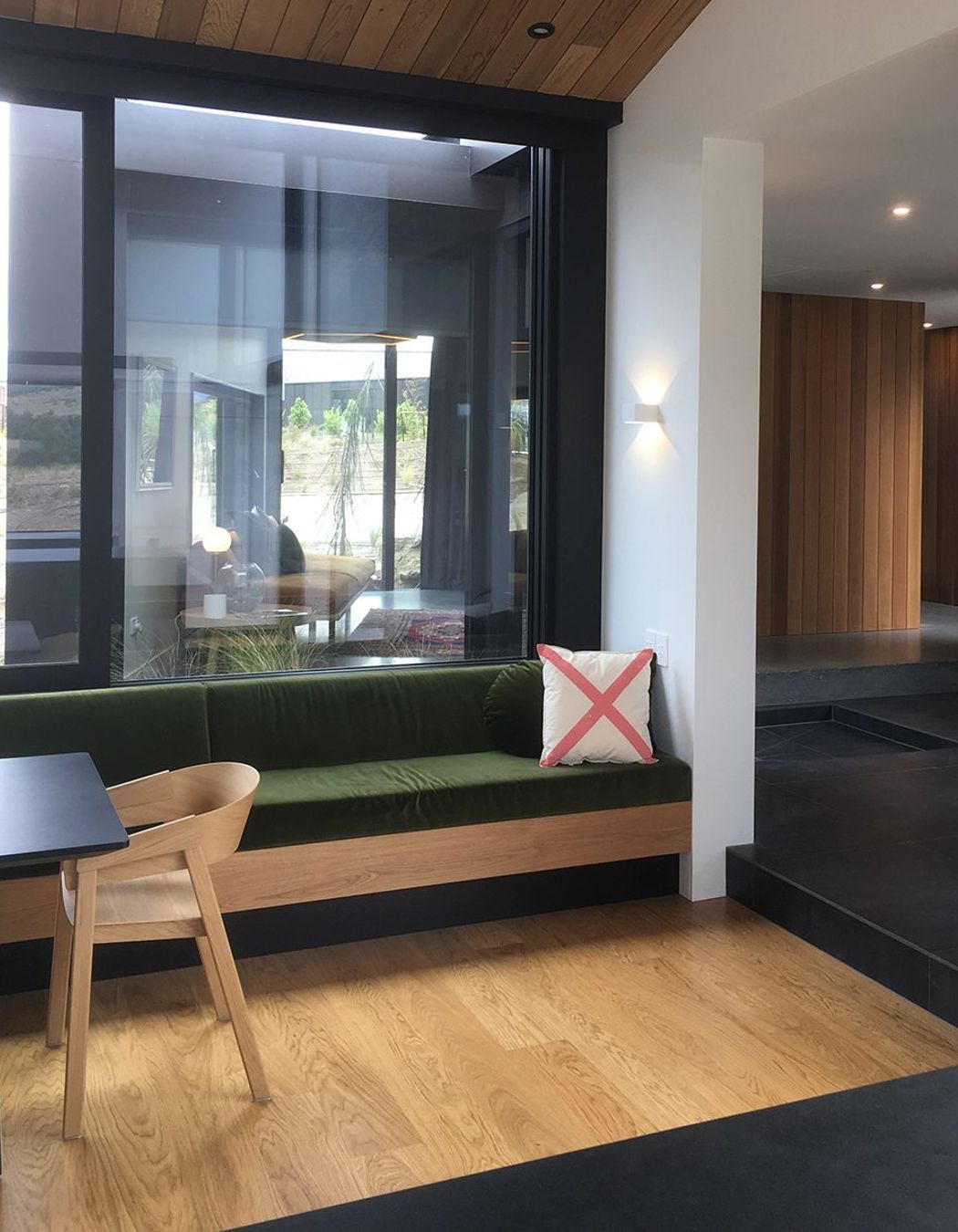 The built-in timber bench seating matches the timber in the flooring and ceilings.