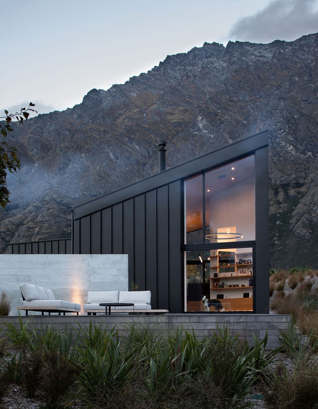 The double-height space in the main living area maximises views of the landscape, while the ground floor opens up into an outside terrace.