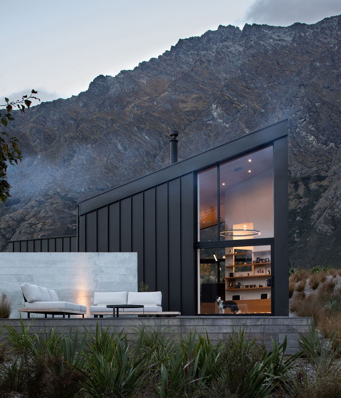 The double-height space in the main living area maximises views of the landscape, while the ground floor opens up into an outside terrace.