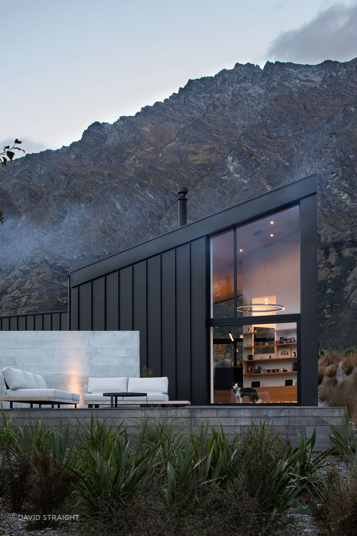 The double-height space in the main living area maximises views of the landscape, while the ground floor opens up into an outside terrace.